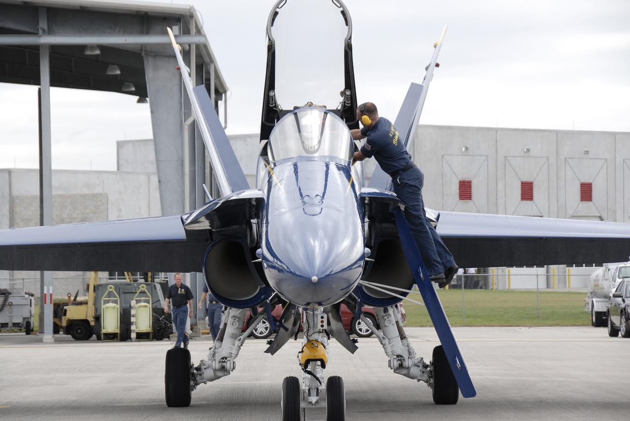 CAPE CANAVERAL, Fla. –  At the Shuttle Landing Facility at NASA's Kennedy Space Center in Florida, ground support personnel work on an F/A-18, one of the U.S. Navy's Blue Angels aircraft.  The demonstration squadron will perform at the Kennedy Space Center Visitor Complex Space and Air Show Nov. 8-9. The Navy's elite flight demonstration squadron will take to the skies in military aircraft demonstrations by the F-16 Fighting Falcon and F/A-18 Super Hornet jets for the second annual Space & Air Show at Kennedy. This year’s show brings together the best in military aircraft, coupled with precision pilots and veteran astronauts to celebrate spaceflight and aviation. The event includes military aircraft demonstrations by the F-16 Fighting Falcon and a water rescue demonstration by the 920th Rescue Wing. Photo credit: NASA/Kim Shiflett