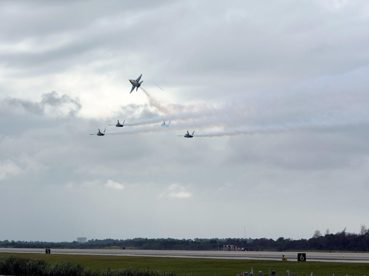 CAPE CANAVERAL, Fla. –  The U.S. Navy's Blue Angels F/A-18 jets fly in formation over the runway at NASA's Kennedy Space Center in Florida before landing.  They are at Kennedy to perform in the Kennedy Space Center Visitor Complex Space and Air Show Nov. 8-9. The Navy's elite flight demonstration squadron will take to the skies in military aircraft demonstrations by the F-16 Fighting Falcon and F/A-18 Super Hornet jets for the second annual Space & Air Show at Kennedy. This year’s show brings together the best in military aircraft, coupled with precision pilots and veteran astronauts to celebrate spaceflight and aviation. The event includes military aircraft demonstrations by the F-16 Fighting Falcon and a water rescue demonstration by the 920th Rescue Wing. Photo credit: NASA/Kim Shiflett