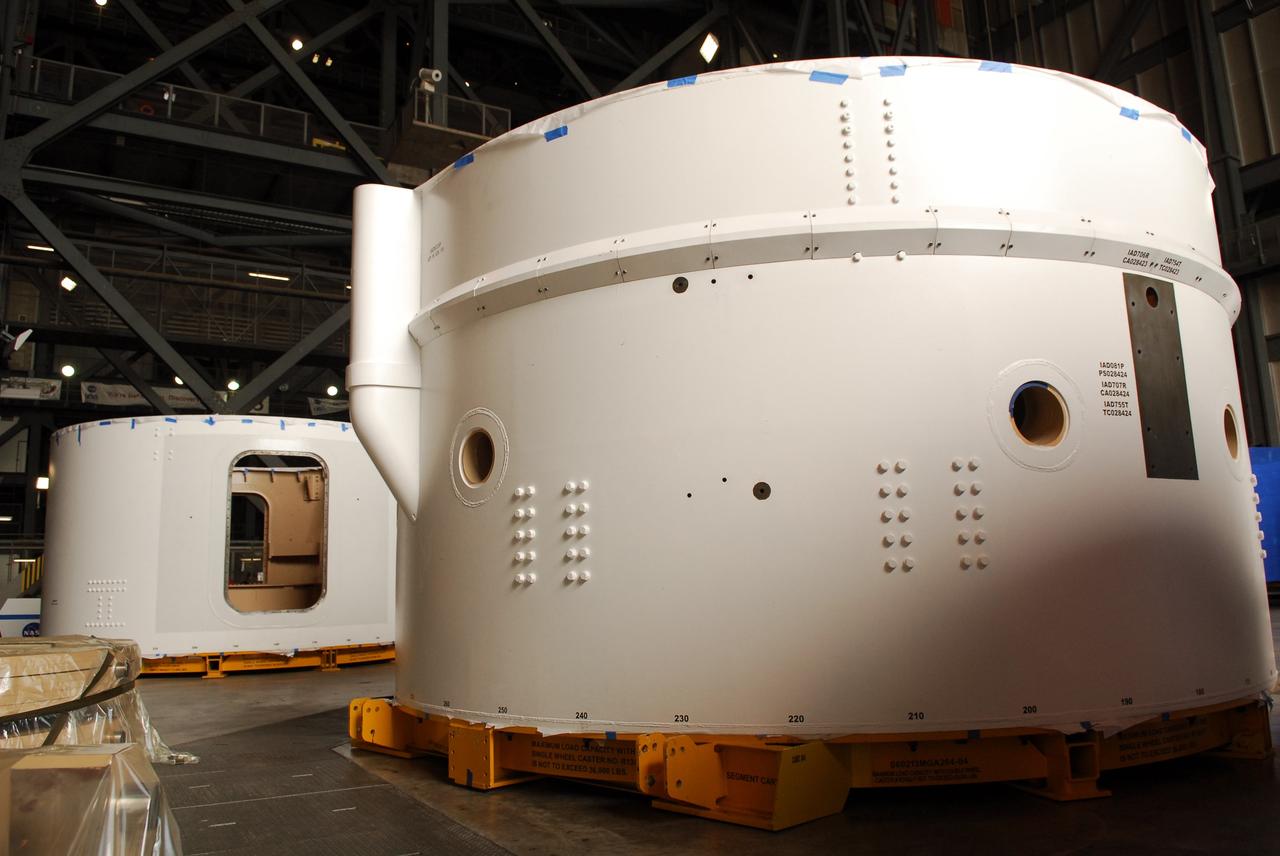 CAPE CANAVERAL, Fla. – Inside the Vehicle Assembly Building high bay 4 at NASA's Kennedy Space Center in Florida, these Ares I-X upper stage simulator segments have shed their protective blue shrink-wrapped covers used for shipping. The upper stage simulator will be used in the test flight identified as Ares I-X in 2009. The segments will simulate the mass and the outer mold line and will be more than 100 feet of the total vehicle height of 327 feet. The simulator comprises 11 segments that are approximately 18 feet in diameter. Most of the segments will be approximately 10 feet high, ranging in weight from 18,000 to 60,000 pounds, for a total of approximately 450,000 pounds. Photo credit: NASA/Troy Cryder