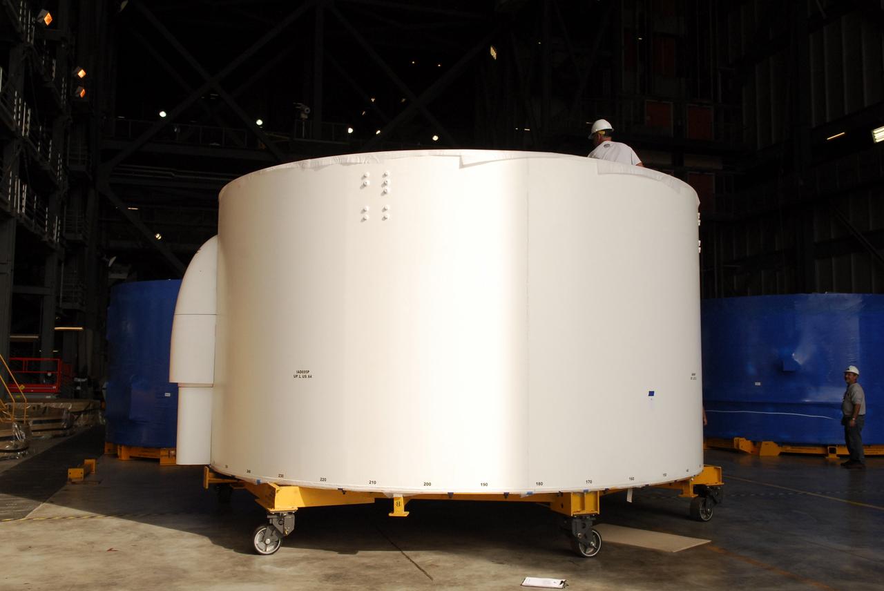 CAPE CANAVERAL, Fla. – Inside the Vehicle Assembly Building high bay 4 at NASA's Kennedy Space Center in Florida, these Ares I-X upper stage simulator segments have shed their protective blue shrink-wrapped covers used for shipping. The upper stage simulator will be used in the test flight identified as Ares I-X in 2009. The segments will simulate the mass and the outer mold line and will be more than 100 feet of the total vehicle height of 327 feet. The simulator comprises 11 segments that are approximately 18 feet in diameter. Most of the segments will be approximately 10 feet high, ranging in weight from 18,000 to 60,000 pounds, for a total of approximately 450,000 pounds. Photo credit: NASA/Troy Cryder