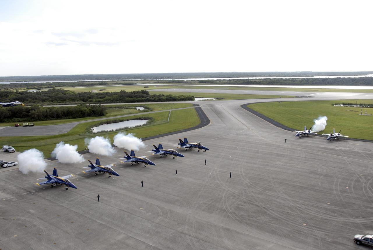 CAPE CANAVERAL, Fla. – The U.S. Navy's F/A-18 Blue Angels (left) and other military aircraft fire their engines on the Shuttle Landing Facility at NASA's Kennedy Space Center in Florida before taking off.  They will be rehearsing their demonstrations for the Kennedy Space Center Visitor Complex Space and Air Show Nov. 8-9. The Navy's elite flight demonstration squadron will take to the skies in military aircraft demonstrations for the second annual Space & Air Show at Kennedy. This year’s show brings together the best in military aircraft, coupled with precision pilots and veteran astronauts to celebrate spaceflight and aviation. The event also includes demonstrations by the F-16 Fighting Falcon and a water rescue demonstration by the 920th Rescue Wing.  Photo credit: NASA/Kim Shiflett