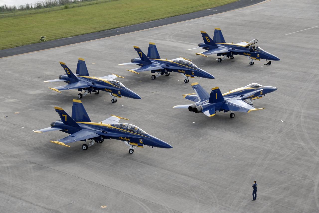 CAPE CANAVERAL, Fla. – The U.S. Navy's F/A-18 Blue Angels begin taxiing toward the runway at the Shuttle Landing Facility at NASA's Kennedy Space Center in Florida.  They will taking off to begin rehearsing their demonstrations for the Kennedy Space Center Visitor Complex Space and Air Show Nov. 8-9. The Navy's elite flight demonstration squadron will take to the skies in military aircraft demonstrations for the second annual Space & Air Show at Kennedy. This year’s show brings together the best in military aircraft, coupled with precision pilots and veteran astronauts to celebrate spaceflight and aviation. The event also includes demonstrations by the F-16 Fighting Falcon and a water rescue demonstration by the 920th Rescue Wing.  Photo credit: NASA/Kim Shiflett