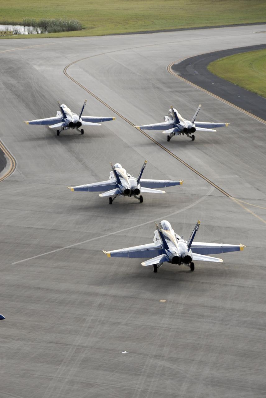 CAPE CANAVERAL, Fla. – The U.S. Navy's F/A-18 Blue Angels taxi toward the runway at the Shuttle Landing Facility at NASA's Kennedy Space Center in Florida.  They will taking off to begin rehearsing their demonstrations for the Kennedy Space Center Visitor Complex Space and Air Show Nov. 8-9.  The Navy's elite flight demonstration squadron will take to the skies in military aircraft demonstrations for the second annual Space & Air Show at Kennedy. This year’s show brings together the best in military aircraft, coupled with precision pilots and veteran astronauts to celebrate spaceflight and aviation. The event also includes demonstrations by the F-16 Fighting Falcon and a water rescue demonstration by the 920th Rescue Wing.  Photo credit: NASA/Kim Shiflett