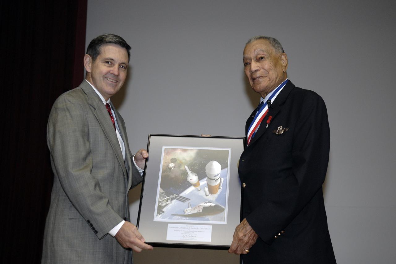 CAPE CANAVERAL, Fla. –  Center Director Bob Cabana presents an award to retired U.S. Air Force Lt. Col. Lee A. Archer Jr., one of the Tuskegee Airmen, during a special presentation to the  work force at NASA's Kennedy Space Center in Florida.  Archer shared his experiences as combat fighter pilot, civil rights leader and business executive.  Archer is the only Tuskegee Airmen fighter pilot to receive the honor “Ace” for shooting down five enemy aircraft during WWII. He retired as Air Force Command Pilot after 30 years of military service, 1941-1971. Archer is at Kennedy to serve as Military Marshall of the 2008 KSC Space & Air Show, Nov. 8-9. Photo credit: NASA/Kim Shiflett