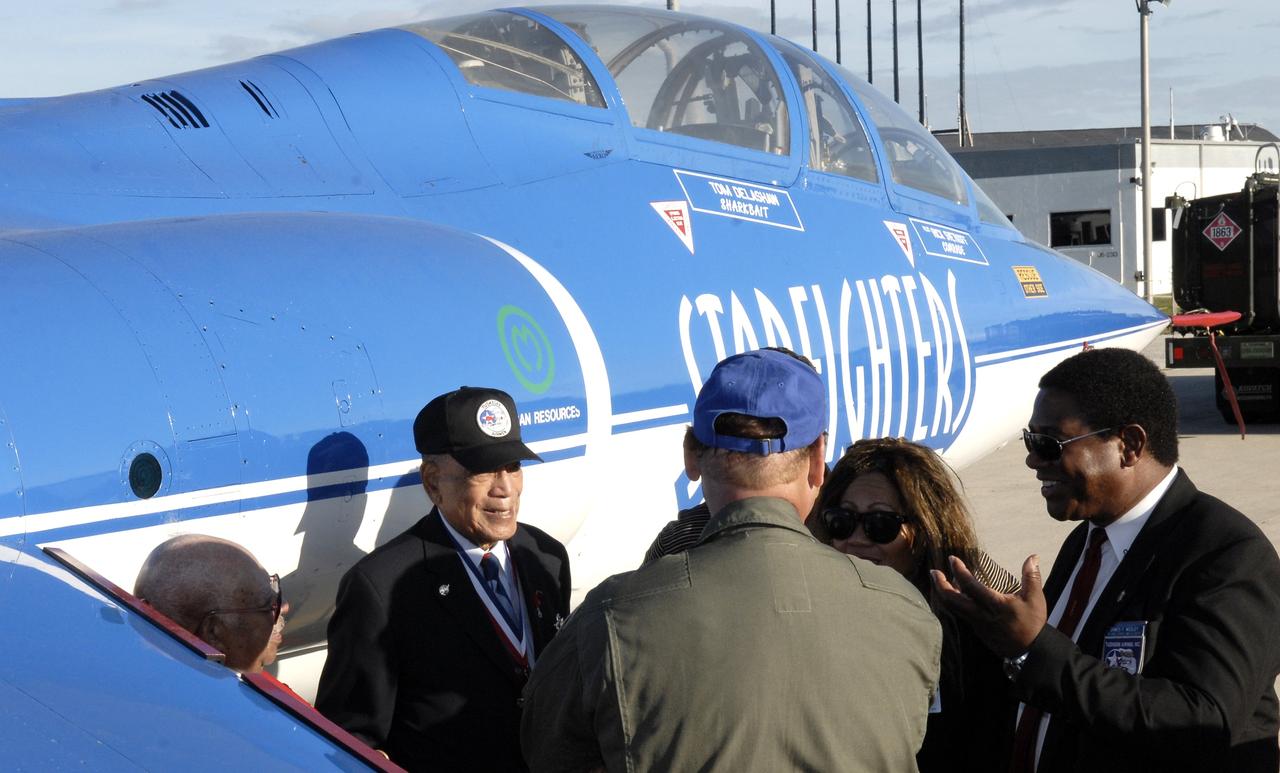 CAPE CANAVERAL, Fla. –   Standing next to a Starfighter aircraft at the Shuttle Landing Facility at NASA's Kennedy Space Center in Florida, retired U.S. Air Force Lt. Col. Lee A. Archer Jr., one of the Tuskegee Airmen, shares his experiences as a combat fighter pilot.  Earlier, Archer made a special presentation to the Kennedy work force, talking about his years as a combat fighter pilot, civil rights leader and business executive. Archer is the only Tuskegee Airmen fighter pilot to receive the honor “Ace” for shooting down five enemy aircraft during WWII. He retired as Air Force Command Pilot after 30 years of military service, 1941-1971. Archer is at Kennedy to serve as Military Marshall of the 2008 KSC Space & Air Show, Nov. 8-9. Photo credit: NASA/Kim Shiflett