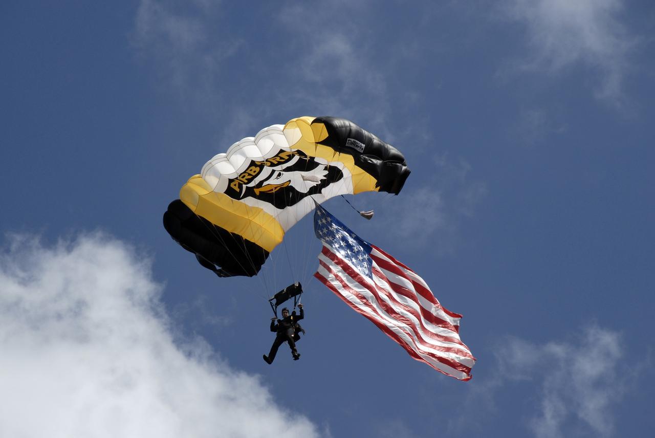 CAPE CANAVERAL, Fla. –   A member of the 101st Airborne parachute demonstration team heads for landing at NASA's Kennedy Space Center in Florida.  The team performed at the Kennedy Space Center Visitor Complex Space and Air Show Nov. 8-9. This year’s show brought together the best in military aircraft, such as the F/A-18 Super Hornet and F-16 Fighting Falcon, coupled with precision pilots and veteran astronauts to celebrate spaceflight and aviation. The event included a water rescue demonstration by the 920th Rescue Wing.  Photo credit: NASA/Kim Shiflett