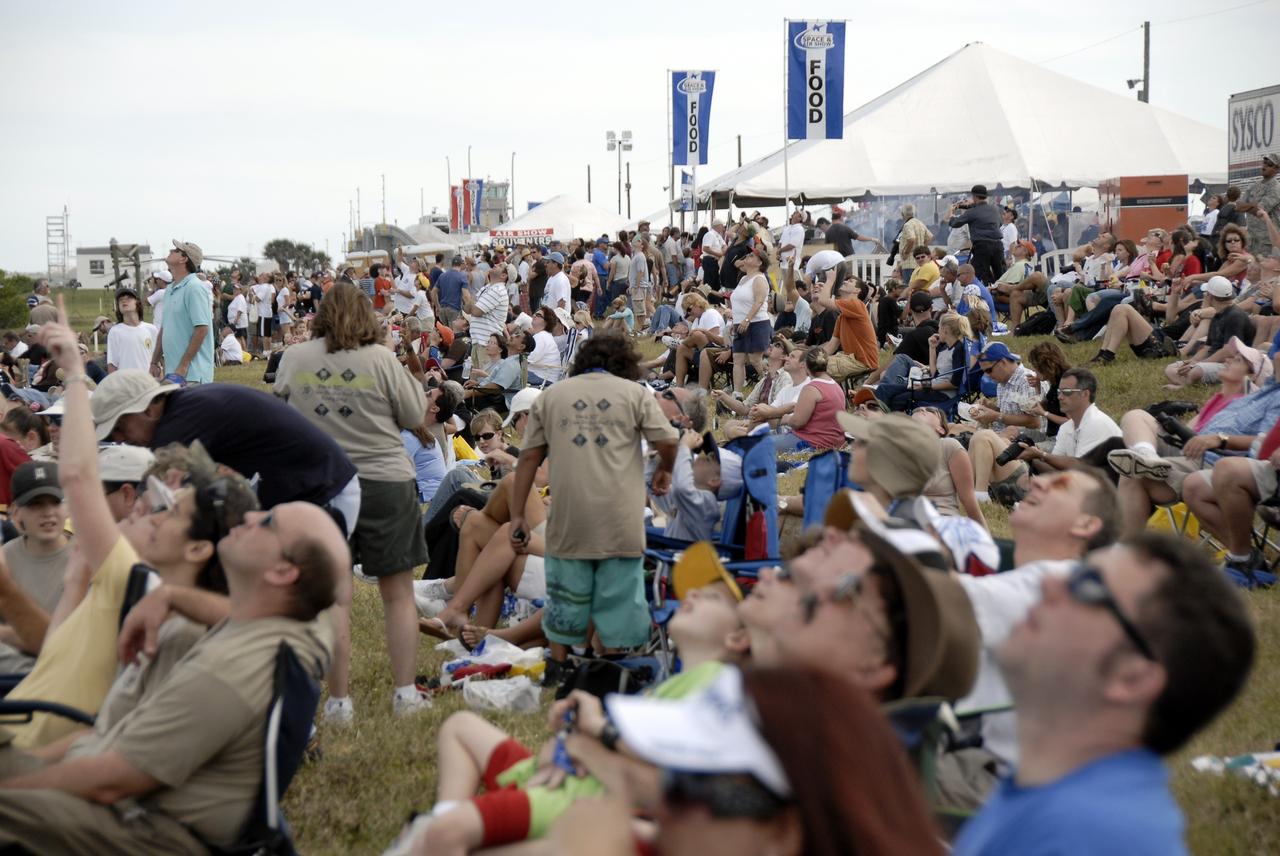 CAPE CANAVERAL, Fla. –  Eyes and hands of the crowd of visitors are pointed toward the sky at NASA's Kennedy Space Center in Florida during the Kennedy Space Center Visitor Complex Space and Air Show Nov. 8-9. This year’s show brought together the best in military aircraft, such as the F/A-18 Super Hornet and F-16 Fighting Falcon, coupled with precision pilots and veteran astronauts to celebrate spaceflight and aviation. The event included a water rescue demonstration by the 920th Rescue Wing.  Photo credit: NASA/Kim Shiflett