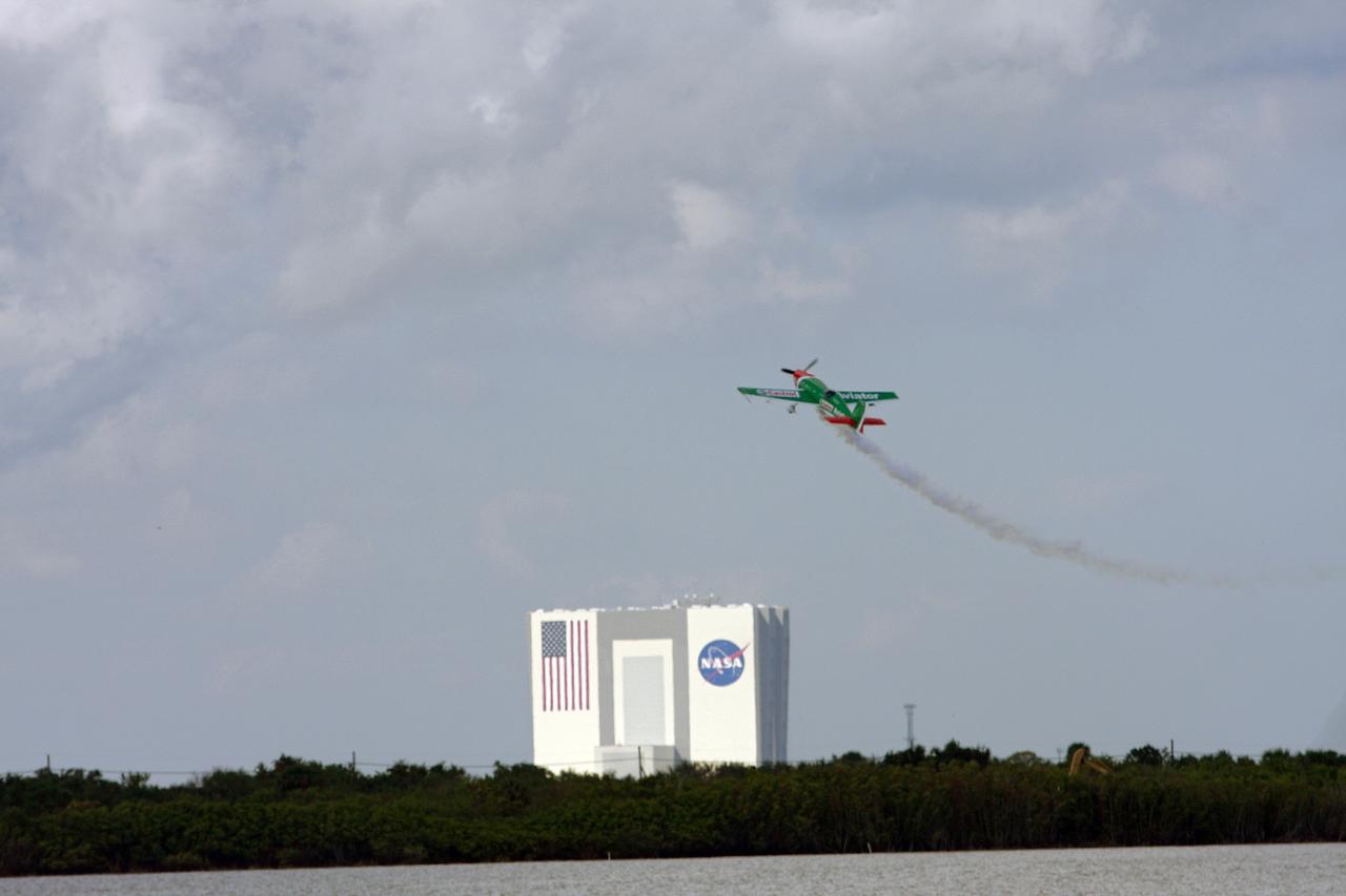 CAPE CANAVERAL, Fla. –  With the Vehicle Assembly Building at NASA's Kennedy Space Center in Florida as a backdrop, this Castrol Aviator EXTRA 300SHP stunt plane, an unlimited-level aerobatic two-seat monoplane, performs aerobatic maneuvers during the Kennedy Space Center Visitor Complex Space and Air Show held Nov. 8-9.  This year’s show brought together the best in military aircraft, such as the F/A-18 Super Hornet and F-16 Fighting Falcon, coupled with precision pilots and veteran astronauts to celebrate spaceflight and aviation. The event included a water rescue demonstration by the 920th Rescue Wing.  Photo credit: NASA/Troy Cryder