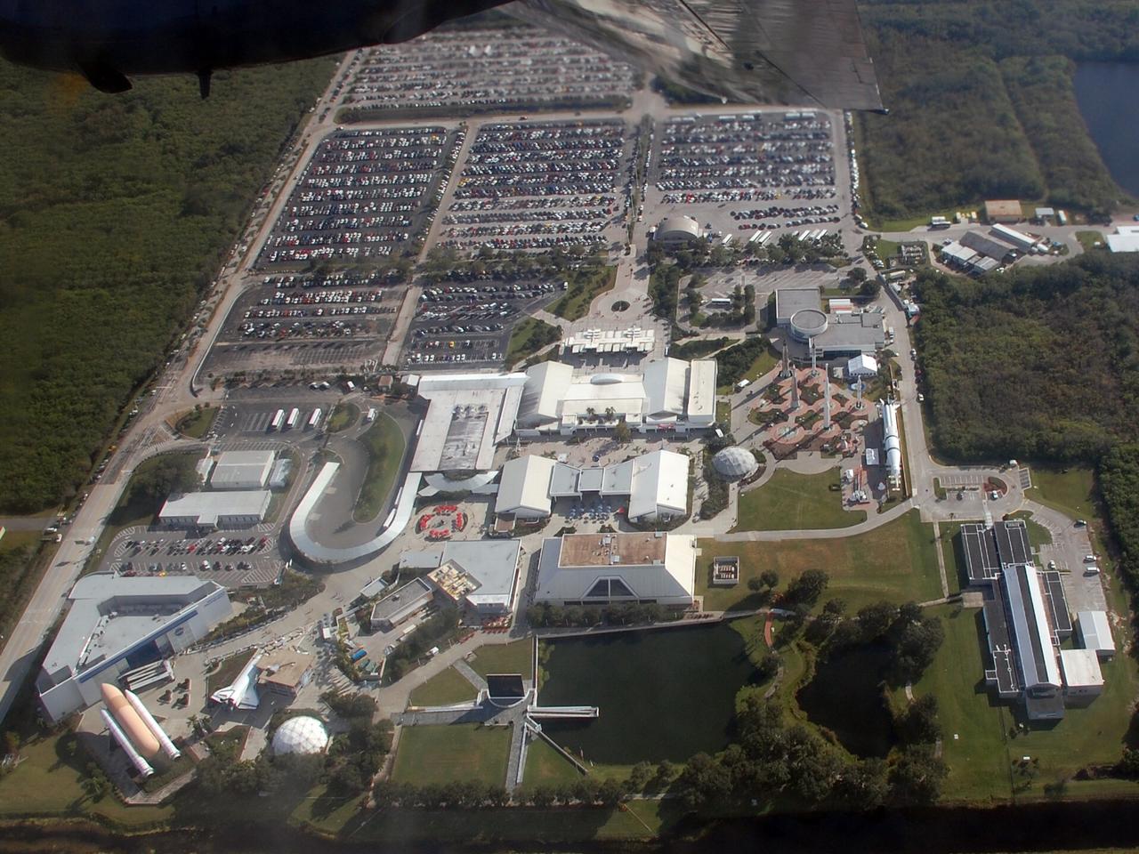 CAPE CANAVERAL, Fla. –   During a flight aboard the U.S. Navy Blue Angel's support aircraft, a C-130T Hercules known as "Fat Albert," the photographer was able to capture the entire Kennedy Space Center Visitor Complex.  Well-known structures are the genuine, full-size solid rocket boosters and external tank at left,  Astronaut Memorial Mirror at center in the foreground, and the Rocket Garden at center right.  The Blue Angels performed during the Kennedy Space Center Visitor Complex Space and Air Show held Nov. 8-9. This year’s show brought together the best in military aircraft, such as the F/A-18 Super Hornet and F-16 Fighting Falcon, coupled with precision pilots and veteran astronauts to celebrate spaceflight and aviation. The event included a water rescue demonstration by the 920th Rescue Wing.  Photo credit: NASA/Ben Smegelsky