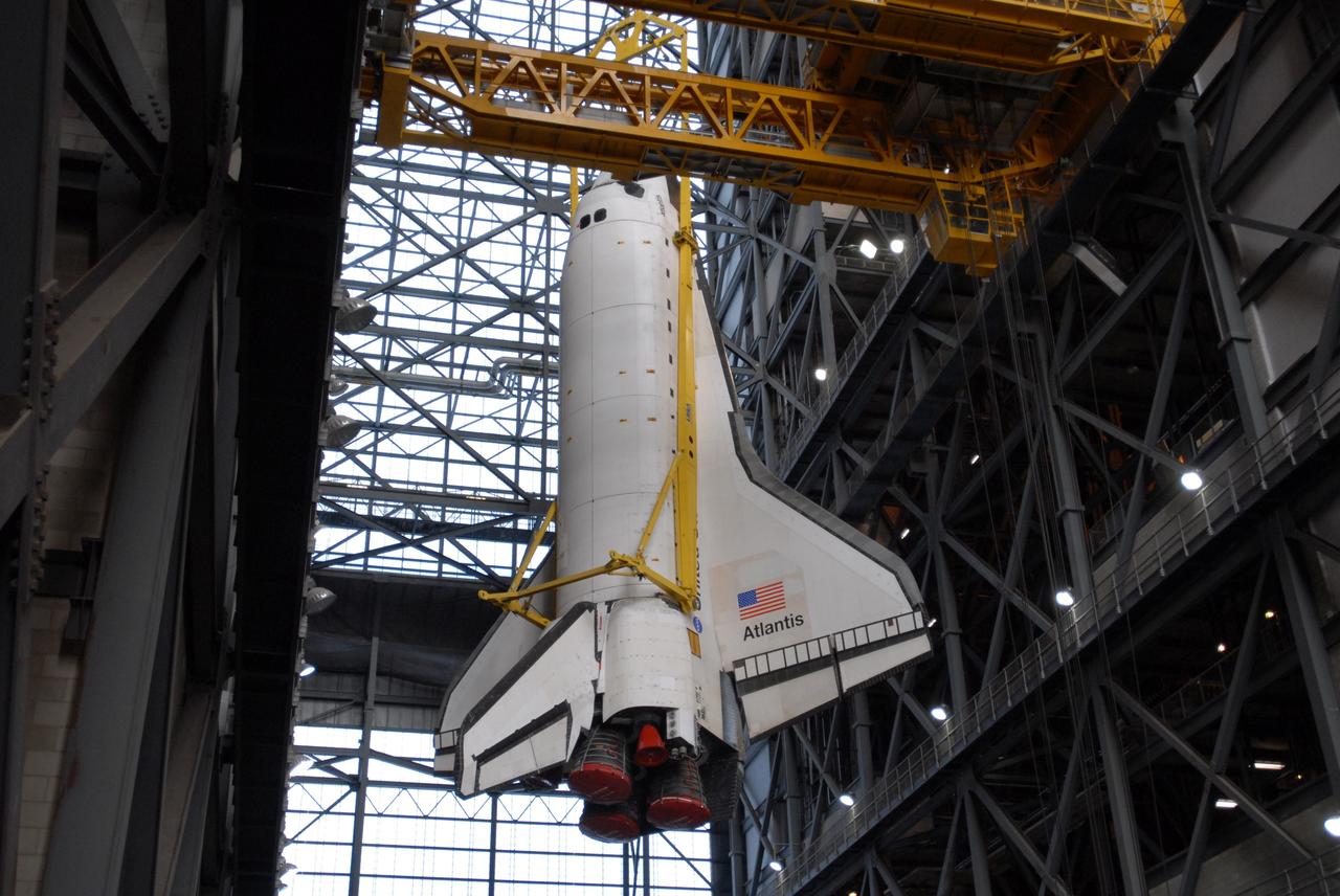 CAPE CANAVERAL, Fla. –  In the Vehicle Assembly Building at NASA's Kennedy Space Center in Florida, space shuttle Atlantis is lowered by a sling toward the transfer aisle floor. Atlantis has been taken off its external fuel tank and solid rocket boosters stack after of the delay of its STS-125 mission to NASA's Hubble Space Telescope.  Atlantis will be returned to the Orbiter Processing Facility. Atlantis' targeted launch on Oct. 14 was delayed when a system that transfers science data from the orbiting observatory to Earth malfunctioned on Sept. 27. The new target launch date is under review. Photo credit: NASA/Jim Grossmann