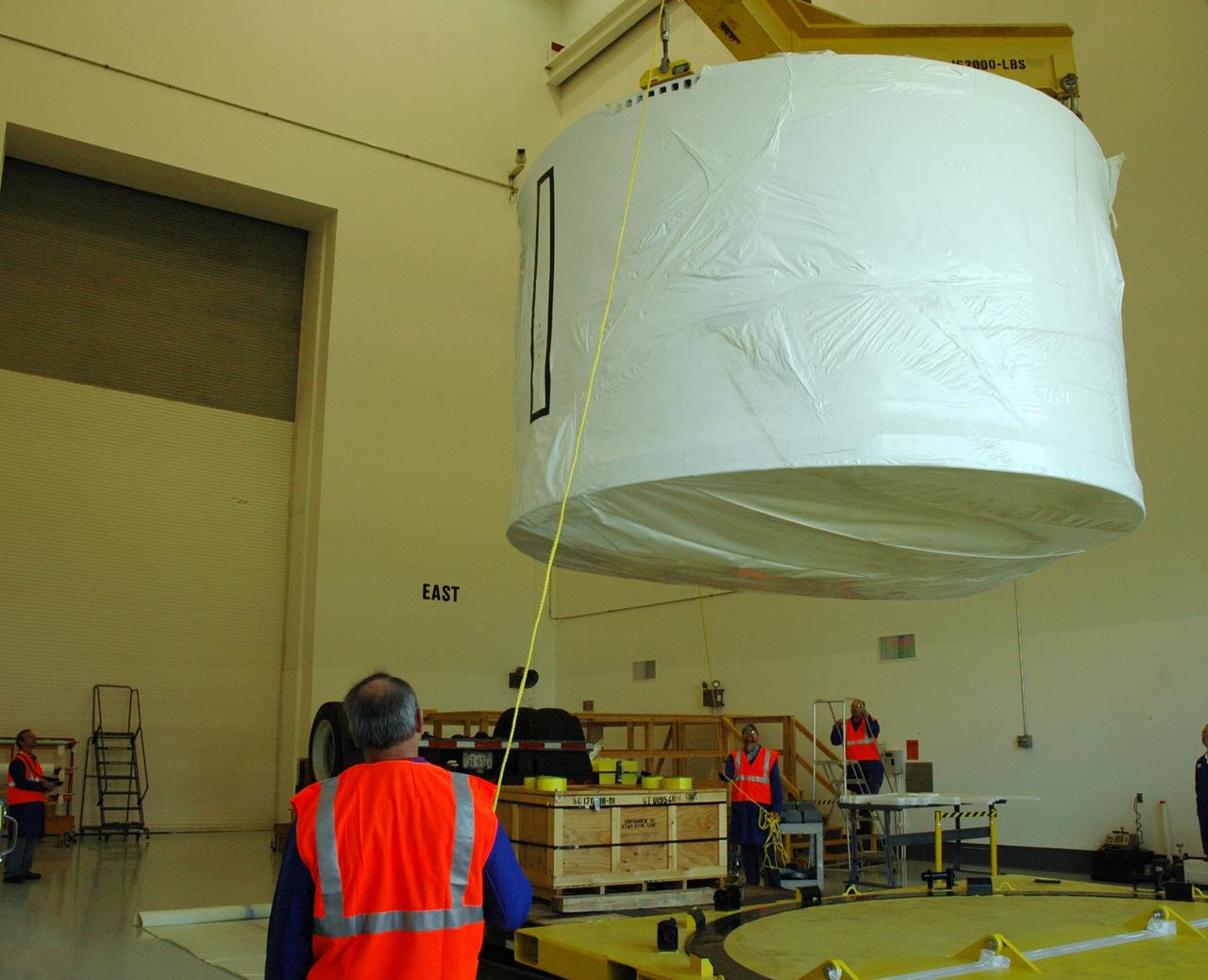 CAPE CANAVERAL, Fla. – The Ares I-X forward skirt is lifted from the transporter that delivered it to Astrotech in Titusville, Fla. The forward skirt will be moved to a stand. Major Tool is subcontractor to Ares I prime contractor Alliant Techsystems Inc., or ATK, in Utah. The forward skirt is the initial piece of first-stage hardware in preparation for the July 2009 test flight of the agency's next-generation spacecraft and launch vehicle system. Built entirely of armored steel, the 14,000-pound segment is seven feet tall and 12-1/4 feet wide. United Space Alliance, under a subcontract to ATK, will integrate and assemble the forward skirt components in the Assembly and Refurbishment Facility at NASA's Kennedy Space Center in Florida.. It will then be moved to the Vehicle Assembly Building high bay 3 for stacking operations. Photo credit: NASA/Tim Jacobs