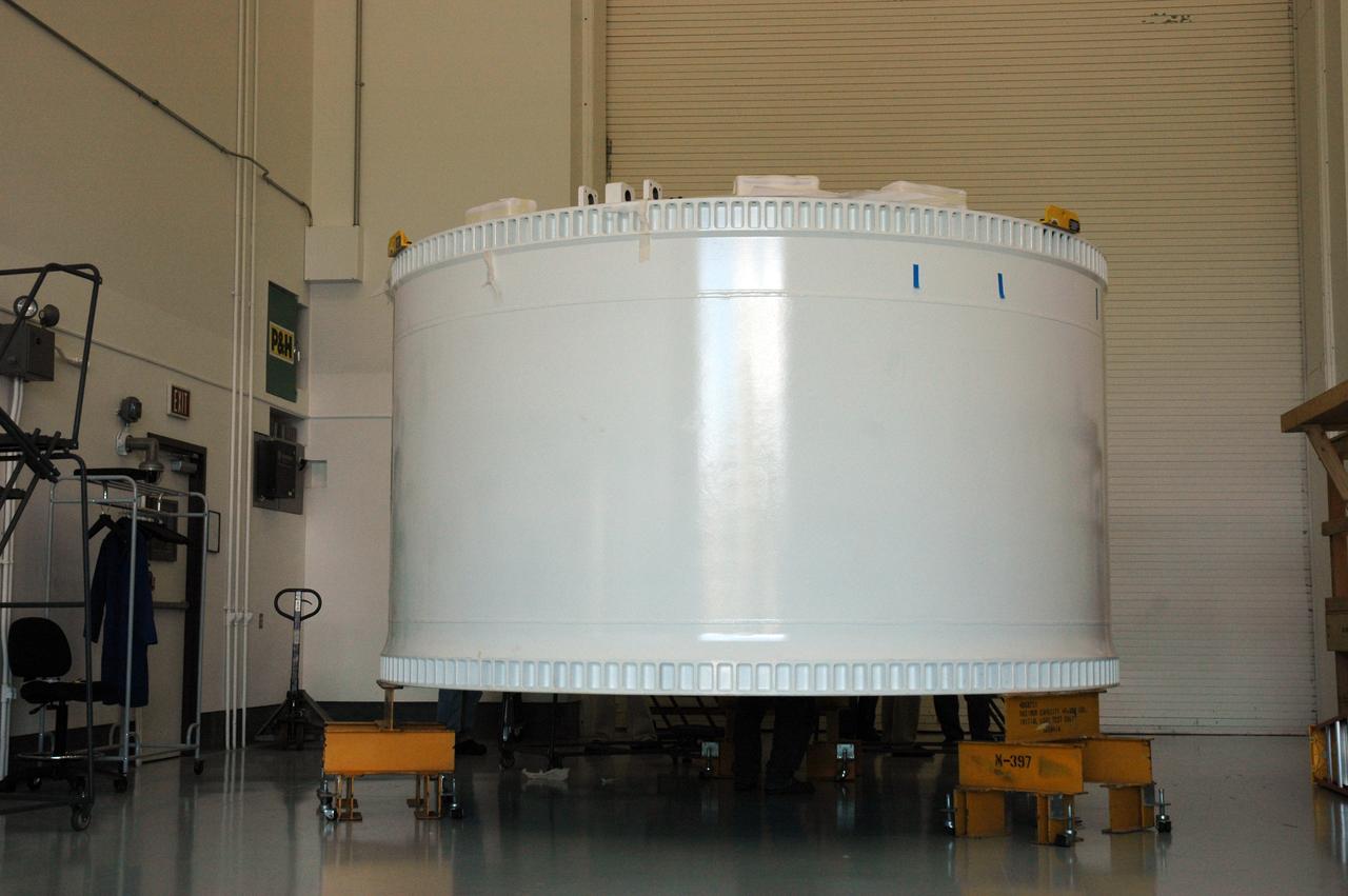 CAPE CANAVERAL, Fla. – At Astrotech in Titusville, Fla., the Ares I-X forward skirt is revealed after its delivery from Major Tool & Machine Inc. in Indiana. Major Tool is subcontractor to Ares I prime contractor Alliant Techsystems Inc., or ATK, in Utah. The forward skirt is the initial piece of first-stage hardware in preparation for the July 2009 test flight of the agency's next-generation spacecraft and launch vehicle system. Built entirely of armored steel, the 14,000-pound segment is seven feet tall and 12-1/4 feet wide. United Space Alliance, under a subcontract to ATK, will integrate and assemble the forward skirt components in the Assembly and Refurbishment Facility at NASA's Kennedy Space Center in Florida.. It will then be moved to the Vehicle Assembly Building high bay 3 for stacking operations. Photo credit: NASA/Tim Jacobs