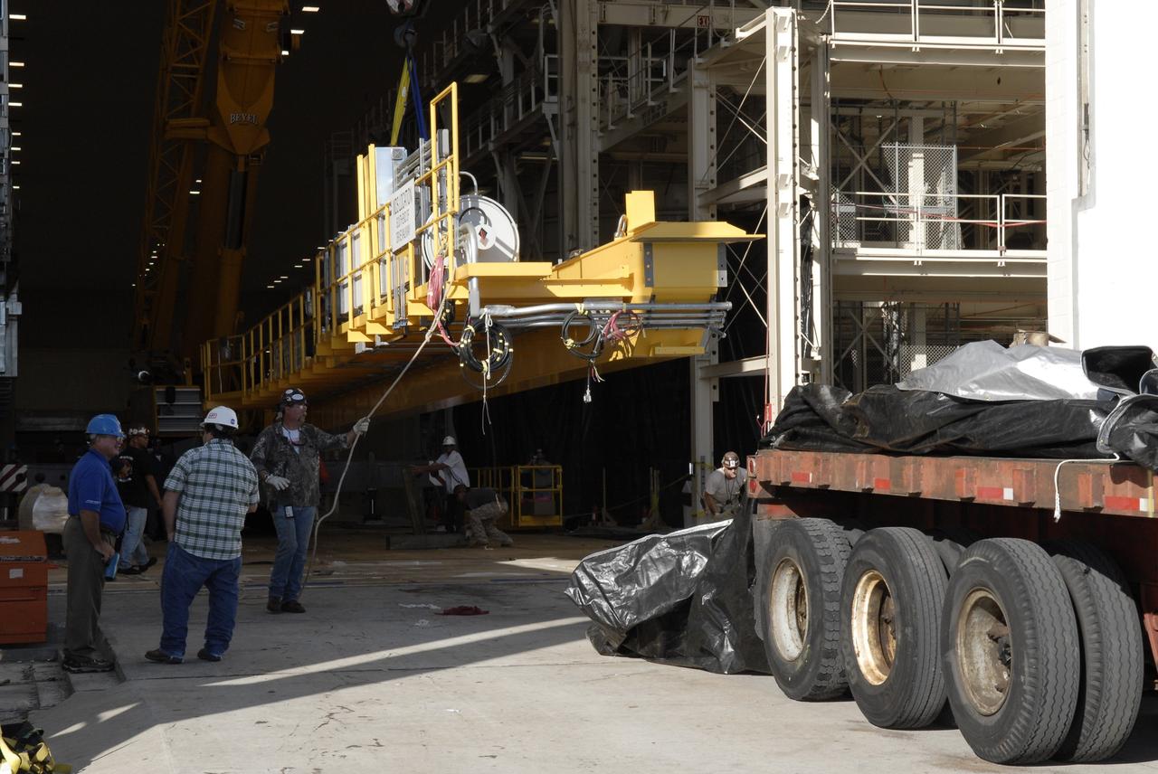 CAPE CANAVERAL, Fla. – Segments of a crane are being offloaded at the Operations and Checkout Building at NASA's Kennedy Space Center in Florida. The new O&C low-bay crane is a 25-ton overhead bridge crane built for Lockheed Martin and Space Florida by American Crane and Equipment Corporation in Douglasville, Pa. The crane has a bridge span of 78’-2” and a hook height of 48’-10”. The crane will be used for lifting and moving flight hardware, fixtures and equipment in support of the Orion spacecraft manufacturing. Part of NASA's Constellation Program, the Orion spacecraft will return humans to the moon and prepare for future voyages to Mars and other destinations in our solar system. Photo credit: NASA/Kim Shiflett