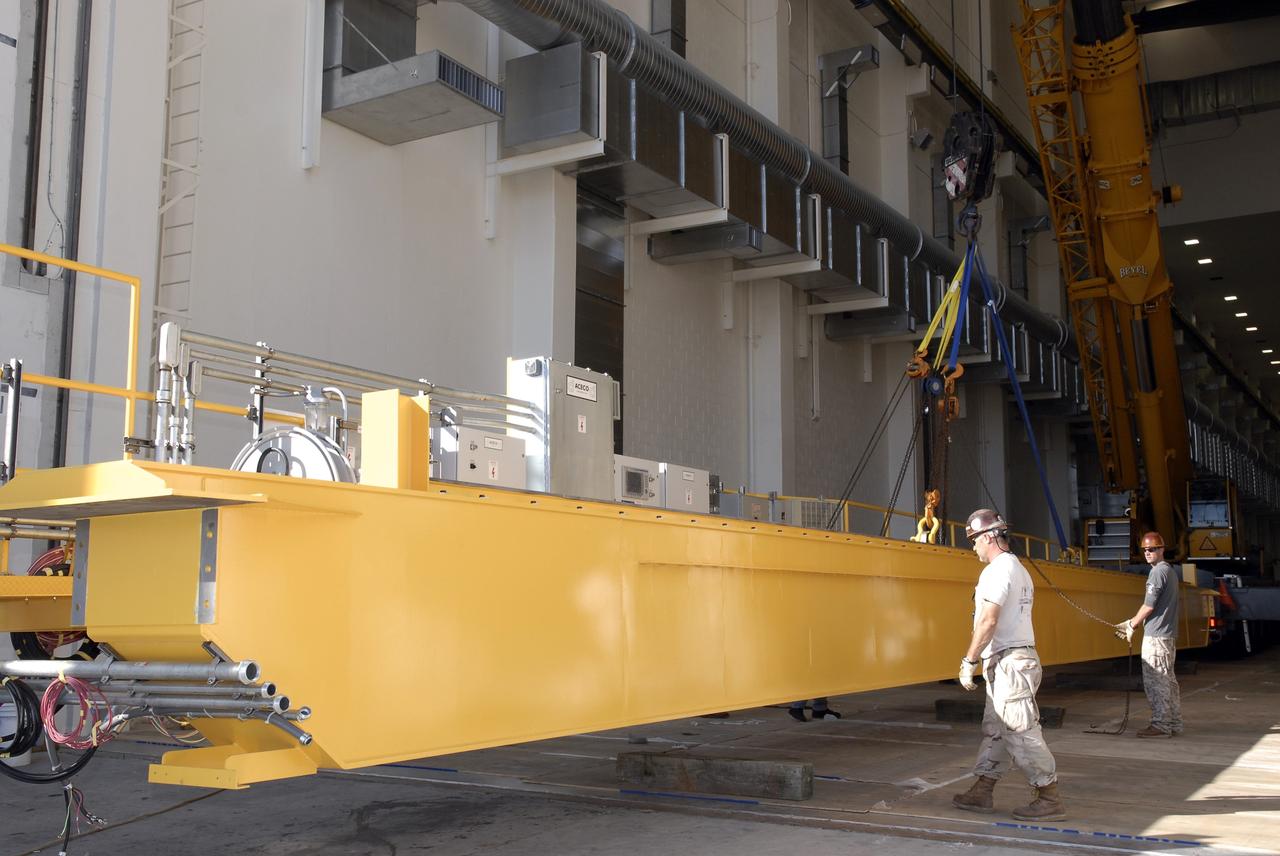 CAPE CANAVERAL, Fla. – Segments of a crane are lowered onto the floor of the Operations and Checkout Building at NASA's Kennedy Space Center in Florida. The new O&C low-bay crane is a 25-ton overhead bridge crane built for Lockheed Martin and Space Florida by American Crane and Equipment Corporation in Douglasville, Pa. The crane has a bridge span of 78’-2” and a hook height of 48’-10”. The crane will be used for lifting and moving flight hardware, fixtures and equipment in support of the Orion spacecraft manufacturing. Part of NASA's Constellation Program, the Orion spacecraft will return humans to the moon and prepare for future voyages to Mars and other destinations in our solar system. Photo credit: NASA/Kim Shiflett