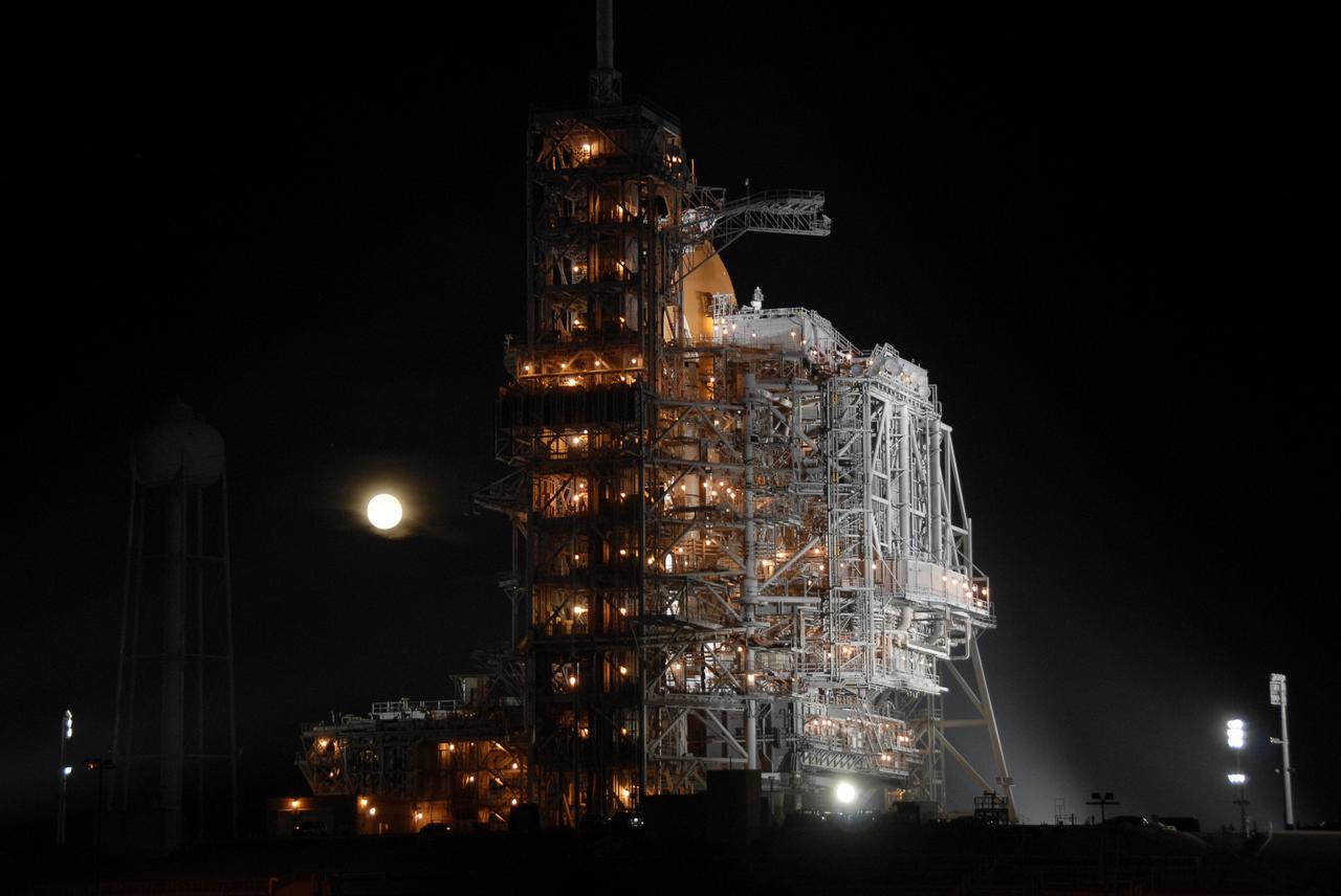 CAPE CANAVERAL, Fla. – With a full moon silhouetted in the night sky, the rotating service structure is ready to be rolled from around space shuttle Endeavour into park position on Launch Pad 39A at NASA's Kennedy Space Center in Florida. The rollback is in preparation for Endeavour's liftoff on the STS-126 mission with a crew of seven. The rotating structure provides protected access to the shuttle for changeout and servicing of payloads at the pad. It is supported by a rotating bridge that pivots on a vertical axis on the west side of the pad's flame trench. After the RSS is rolled back, the orbiter is ready for fuel cell activation and external tank cryogenic propellant loading operations. The STS-126 mission will be the 124th space shuttle flight and the 27th flight to the International Space Station. The mission will feature four spacewalks and work that will prepare the space station to house six crew members for long- duration missions. Liftoff is scheduled for 7:55 p.m. EST Nov. 14. Photo credit: NASA/Kim Shiflett