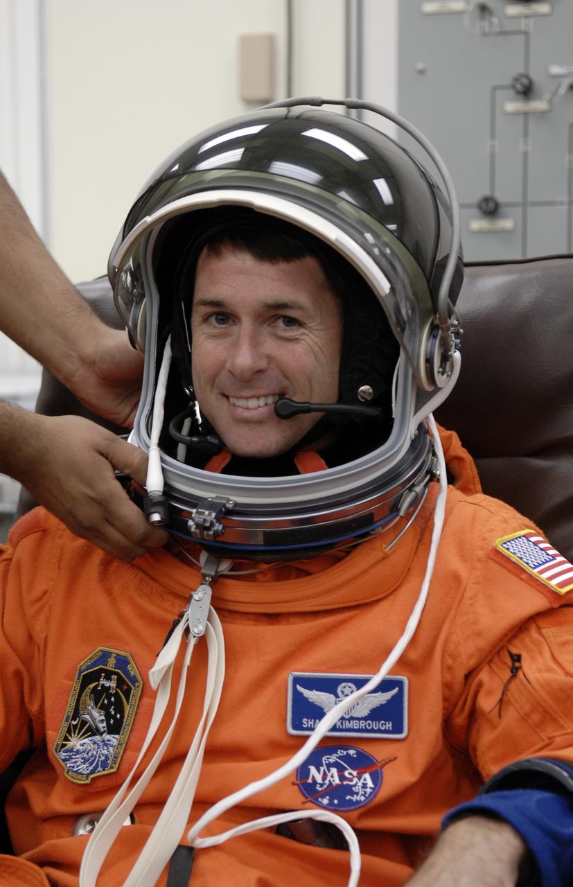 CAPE CANAVERAL, Fla. – Crew members for space shuttle Endeavour's STS-126 mission put on their launch and entry suits before heading to Launch Pad 39A at NASA's Kennedy Space Center in Florida. Mission Specialist Shane Kimbrough dons his helmet. STS-126 is the 124th space shuttle flight and the 27th flight to the International Space Station. The mission will feature four spacewalks and work that will prepare the space station to house six crew members for long- duration missions. Liftoff is scheduled for 7:55 p.m. EST Nov. 14. Photo credit: NASA/Kim Shiflett