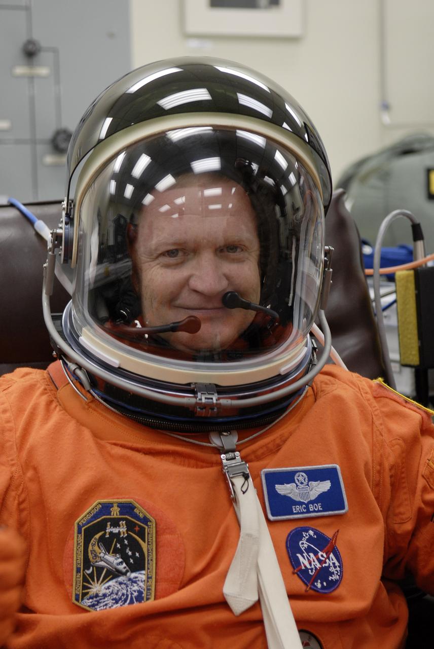 CAPE CANAVERAL, Fla. – Crew members for space shuttle Endeavour's STS-126 mission put on their launch and entry suits before heading to Launch Pad 39A at NASA's Kennedy Space Center in Florida. Pilot Eric Boe, who is making his first shuttle flight, dons his helmet. STS-126 is the 124th space shuttle flight and the 27th flight to the International Space Station. The mission will feature four spacewalks and work that will prepare the space station to house six crew members for long- duration missions. Liftoff is scheduled for 7:55 p.m. EST Nov. 14. Photo credit: NASA/Kim Shiflett
