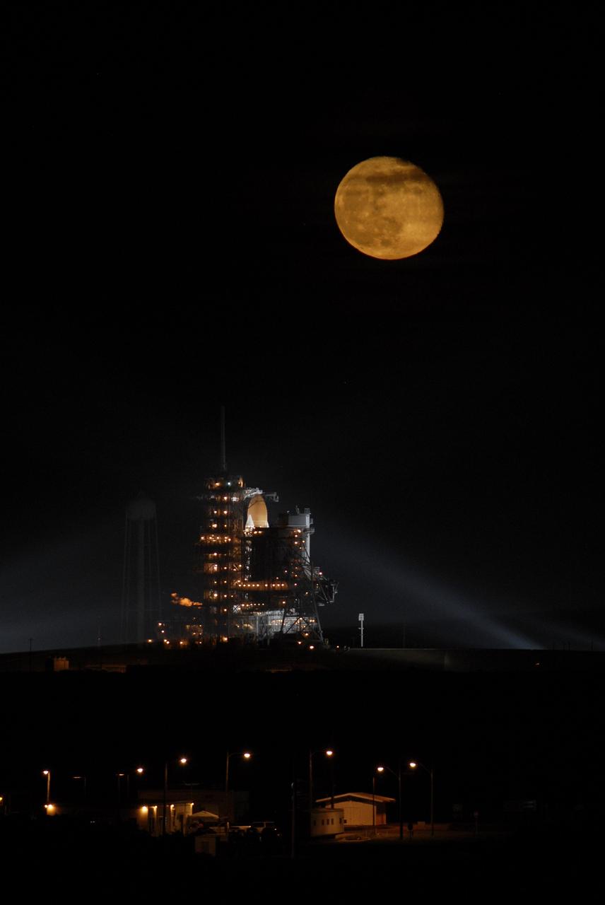 CAPE CANAVERAL, Fla. – Above Launch Pad 39A at NASA's Kennedy Space Center in Florida, the full moon hovers over space shuttle Endeavour waiting for liftoff on the STS-126 mission. Liftoff was scheduled for 7:55 p.m. EST. STS-126 is the 124th space shuttle flight and the 27th flight to the International Space Station. The mission will feature four spacewalks and work that will prepare the space station to house six crew members for long- duration missions. Photo credit: NASA/Kim Shiflett