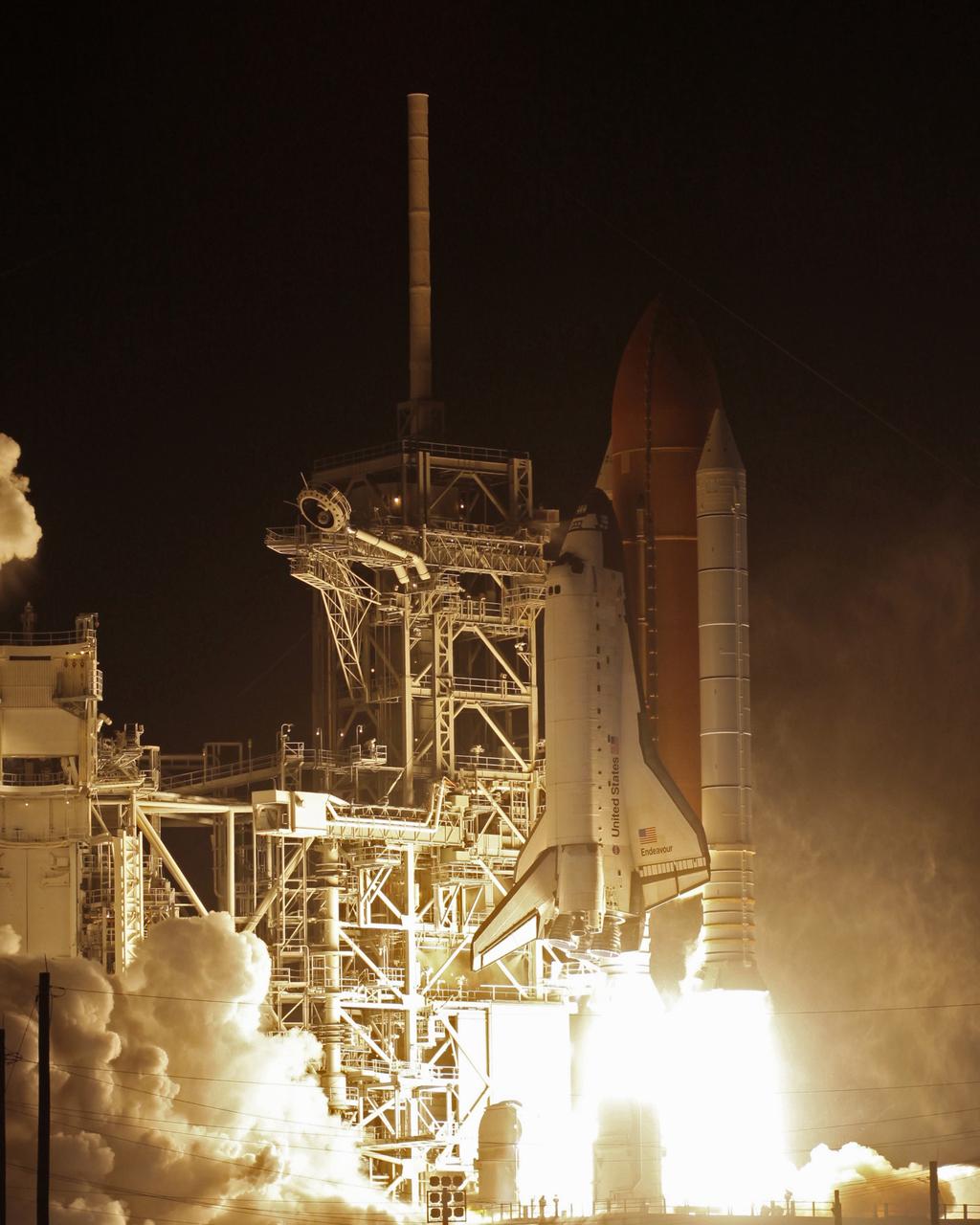 CAPE CANAVERAL, Fla. – Light-filled clouds of smoke and steam roll across Launch Pad 39A at NASA's Kennedy Space Center as space shuttle Endeavour roars into the night sky on the STS-126 mission. Liftoff was on time at 7:55 p.m. EST. STS-126 is the 124th space shuttle flight and the 27th flight to the International Space Station. The mission will feature four spacewalks and work that will prepare the space station to house six crew members for long- duration missions. Photo courtesy of Scott Andrews