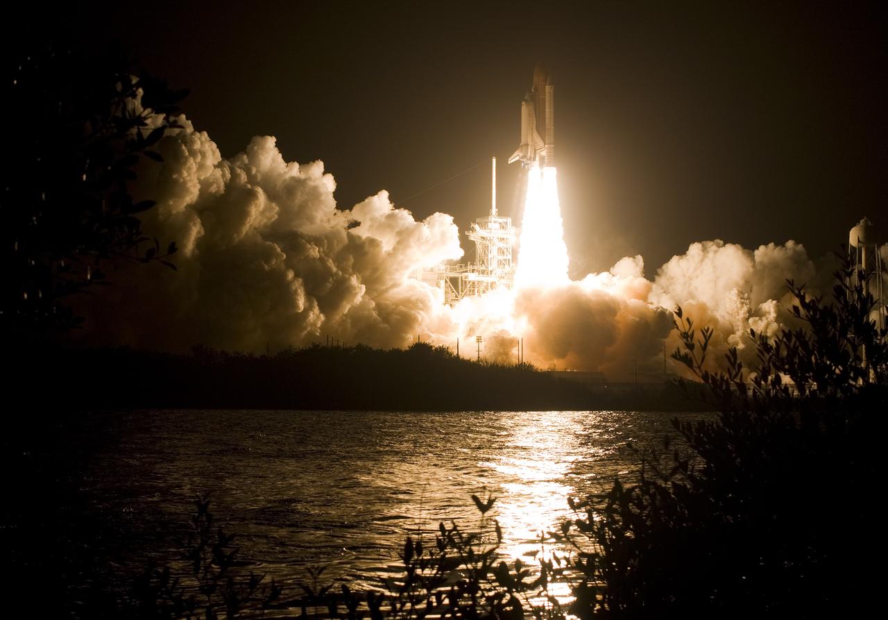 CAPE CANAVERAL, Fla. – The water next to Launch Pad 39A at NASA's Kennedy Space Center in Florida captures the brilliance of the launch of space shuttle Endeavour on its STS-126 mission while billows of smoke and steam roll across the pad.   Liftoff was on time at 7:55 p.m. EST. STS-126 is the 124th space shuttle flight and the 27th flight to the International Space Station. The mission will feature four spacewalks and work that will prepare the space station to house six crew members for long-duration missions. Photo courtesy of Scott Andrews