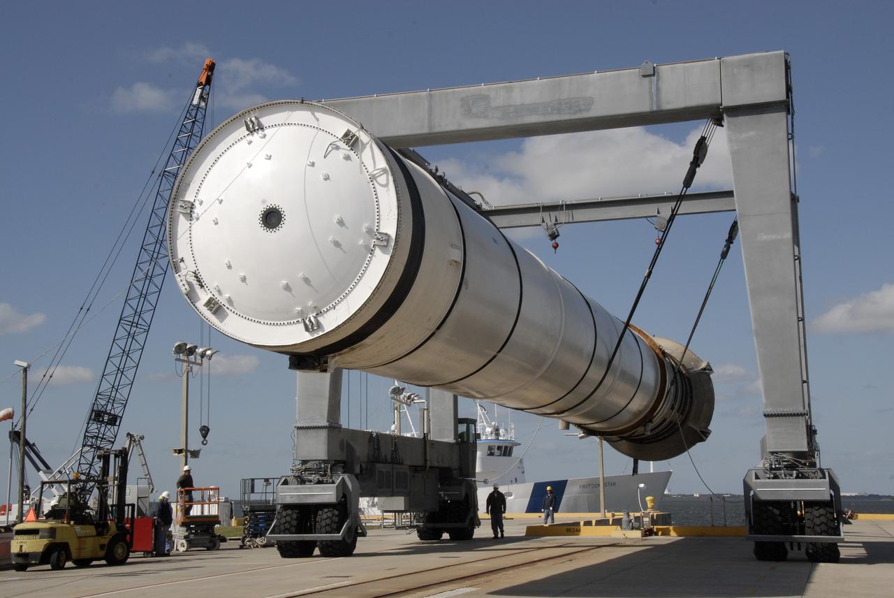 CAPE CANAVERAL, Fla. –   At the dock at Hangar AF at Cape Canaveral Air Force Station in Florida, the straddle crane lifts a spent solid rocket booster to allow saltwater contamination to be rinsed off. The booster is from space shuttle Endeavour, which launched Nov. 14 on the STS-126 mission. The space shuttle’s solid rocket booster casings and associated flight hardware are recovered at sea. The spent rocket was recovered by NASA's Solid Rocket Booster Retrieval Ship Freedom Star. The boosters impact the Atlantic Ocean approximately seven minutes after liftoff. The splashdown area is a square of about six by nine nautical miles located about 140 nautical miles downrange from the launch pad. The retrieval ships are stationed approximately 8 to 10 nautical miles from the impact area at the time of splashdown. As soon as the boosters enter the water, the ships accelerate to a speed of 15 knots and quickly close on the boosters. The pilot chutes and main parachutes are the first items to be brought on board. With the chutes and frustum recovered, attention turns to the boosters. The ship’s tow line is connected and the booster is returned to the Port and, after transfer to a position alongside the ship, to Hangar AF. There, the expended boosters are disassembled, refurbished and reloaded with solid propellant for reuse. Photo credit: NASA/Kim Shiflett