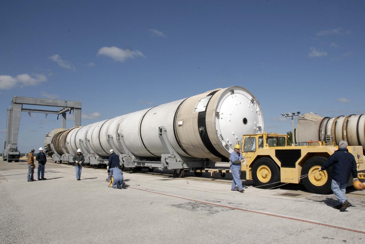 CAPE CANAVERAL, Fla. –   At the dock at Hangar AF at Cape Canaveral Air Force Station in Florida, two spent solid rocket boosters begin moving to the hangar for the safing process. They will be driven through the washing bay for a cleaning and rinsing. The boosters are from space shuttle Endeavour, which launched Nov. 14 on the STS-126 mission. The space shuttle’s solid rocket booster casings and associated flight hardware are recovered at sea. The boosters impact the Atlantic Ocean approximately seven minutes after liftoff. The splashdown area is a square of about six by nine nautical miles located about 140 nautical miles downrange from the launch pad. The retrieval ships are stationed approximately 8 to 10 nautical miles from the impact area at the time of splashdown. As soon as the boosters enter the water, the ships accelerate to a speed of 15 knots and quickly close on the boosters. The pilot chutes and main parachutes are the first items to be brought on board. With the chutes and frustum recovered, attention turns to the boosters. The ship’s tow line is connected and the booster is returned to the Port and, after transfer to a position alongside the ship, to Hangar AF. There, the expended boosters are disassembled, refurbished and reloaded with solid propellant for reuse. Photo credit: NASA/Kim Shiflett