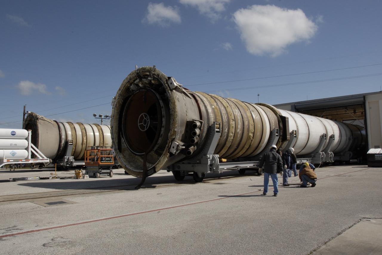 CAPE CANAVERAL, Fla. –   At Hangar AF at Cape Canaveral Air Force Station in Florida, two spent solid rocket boosters move into the washing bay for a cleaning and rinsing. The boosters are from space shuttle Endeavour, which launched Nov. 14 on the STS-126 mission. The space shuttle’s solid rocket booster casings and associated flight hardware are recovered at sea. The boosters impact the Atlantic Ocean approximately seven minutes after liftoff. The splashdown area is a square of about six by nine nautical miles located about 140 nautical miles downrange from the launch pad. The retrieval ships are stationed approximately 8 to 10 nautical miles from the impact area at the time of splashdown. As soon as the boosters enter the water, the ships accelerate to a speed of 15 knots and quickly close on the boosters. The pilot chutes and main parachutes are the first items to be brought on board. With the chutes and frustum recovered, attention turns to the boosters. The ship’s tow line is connected and the booster is returned to the Port and, after transfer to a position alongside the ship, to Hangar AF. There, the expended boosters are disassembled, refurbished and reloaded with solid propellant for reuse. Photo credit: NASA/Kim Shiflett
