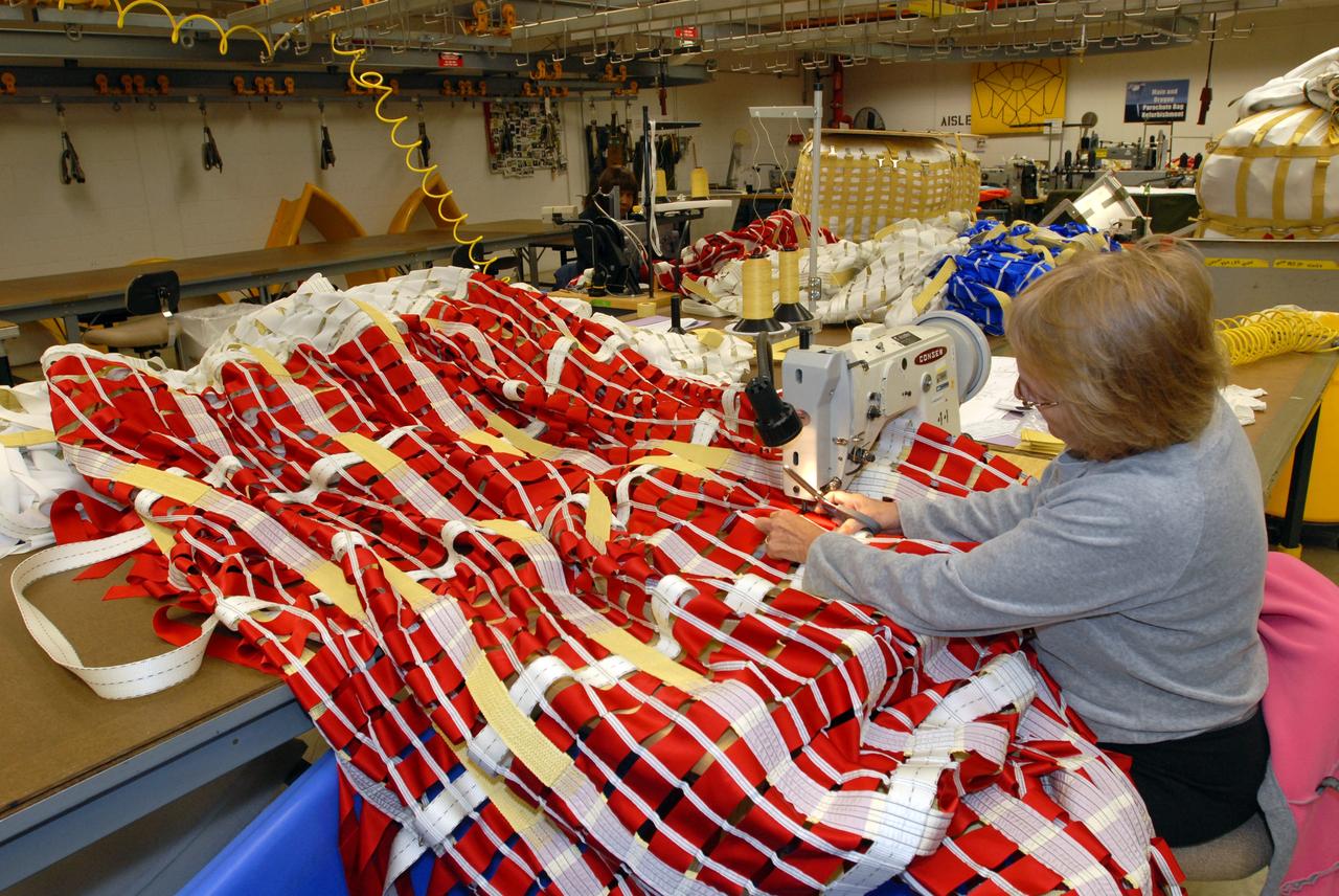 CAPE CANAVERAL, Fla. – In the Parachute Refurbishment Facility at NASA's Kennedy Space Center in Florida, workers repair the parachutes recovered from sea after the launch of space shuttle Endeavour on the STS-126 mission. Typically, each main canopy requires hundreds of repairs after each use. The smaller chutes and the parachute deployment bags they are packed in also require repairs. The parachutes are used to slow the descent of the solid rocket boosters that are jettisoned during liftoff. One pilot, one drogue and three main canopies per booster slow the booster’s fall from about 360 mph to 50 mph.  After the chutes are cleaned and repaired, they must be carefully packed into their bags so they will deploy correctly the next time they are used. Photo credit: NASA/Jim Grossmann