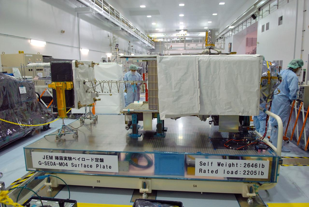 CAPE CANAVERAL, Fla. – In the Space Station Processing Facility at NASA's Kennedy Space Center in Florida, workers deploy the mast on the SEDA-AP or Space Environment Data Acquisition equipment--Attached Payload. SEDA-AP will measure space environment in ISS orbit and environmental effects on materials and electronic devices to investigate the interaction with and from the environment at the Kibo exposed facility.  The payload will be installed on the Japanese Experiment Module's Experiment Logistics Module-Exposed Section, or ELM-ES.  The ELM-ES is one of the final components of the Japan Aerospace Exploration Agency's Kibo laboratory for the International Space Station.  It can provide payload storage space and can carry up to three payloads at launch. In addition, the ELM-ES provides a logistics function where it can be returned to the ground aboard the space shuttle. The ELM-ES will be carried aboard space shuttle Endeavour on the STS-127 mission targeted for launch May 15.  Photo credit: NASA/Cory Huston