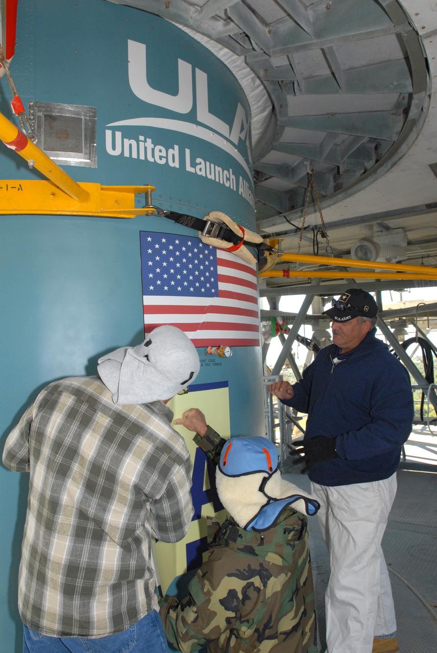CAPE CANAVERAL, Fla. – Workers at Launch Complex 17-B on Cape Canaveral Air Force Station in Florida place the large patch that describes the Kepler spacecraft mission to be launched on the Delta 2 rocket. The Kepler mission is specifically designed to survey our region of the Milky Way galaxy to discover hundreds of Earth-size and smaller planets in or near the habitable zone and determine how many of the billions of stars in our galaxy have such planets. Results from this mission will allow us to place our solar system within the continuum of planetary systems in the Galaxy. Photo credit: NASA/Jim Grossmann