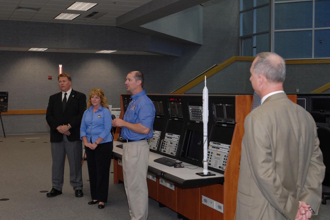 CAPE CANAVERAL, Fla. –  At a media event in Firing Room 1 of the Launch Control Center, NASA management talk about the Ares I-X being assembled at NASA's Kennedy Space Center in Florida.  From left are Shuttle Test Director Jeff Spaulding, Deputy Mission Manager Carol Scott, Constellation Projects Office Director Pepper Phillips and Chief of the NASA Launch and Landing Division Pete Nickolenko. The upper stage simulators will be used in the test flight identified as Ares I-X in 2009. The segments will simulate the mass and the outer mold line and will be more than 100 feet of the total vehicle height of 327 feet. The simulator comprises 11 segments that are approximately 18 feet in diameter. Most of the segments will be approximately 10 feet high, ranging in weight from 18,000 to 60,000 pounds, for a total of approximately 450,000 pounds.   Photo credit: NASA/Jim Grossmann