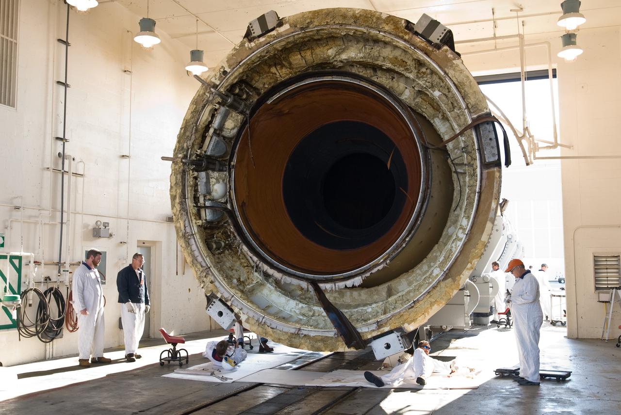 CAPE CANAVERAL, Fla. –  At Hangar AF at Cape Canaveral Air Force Station in Florida, workers inspect the aft section of one of two spent solid rocket boosters from space shuttle Endeavour, which launched Nov. 14 on the STS-126 mission.  The space shuttle’s solid rocket booster casings and associated flight hardware are recovered at sea after being jettisoned. The boosters impact the Atlantic Ocean approximately seven minutes after liftoff. After their recovery and transport to Hangar AF, the boosters are cleaned, inspected, disassembled, refurbished and reloaded with solid propellant for reuse.  Photo credit: NASA/Jim Grossmann