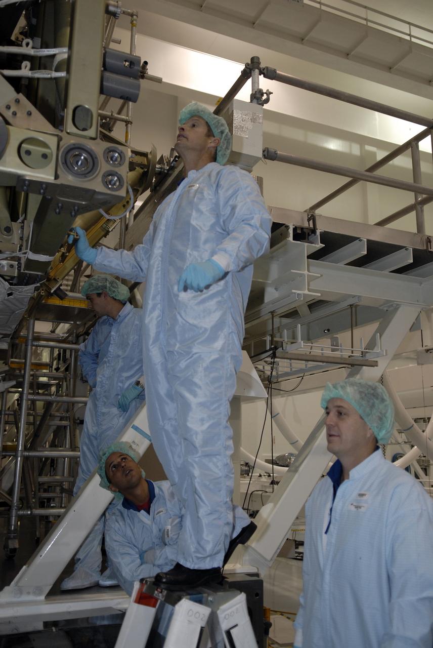CAPE CANAVERAL, Fla. -- In the Space Station Processing Facility at NASA's Kennedy Space Center in Florida, STS-119 crew members take a close look at the S6 truss that is the primary payload on the mission. Standing are (left) Mission Specialist Richard Arnold and (right) Mission Specialist Steve Swanson. Below are (left) Mission Specialist Joseph Acaba and (right) Pilot Tony Antonelli. The crew is at Kennedy for a Crew Equipment Interface Test that provides experience handling tools, equipment and hardware they will use on the mission. On the STS-119 mission, space shuttle Discovery will carry the S6 truss segment to complete the 361-foot-long backbone of the International Space Station. The truss includes the fourth pair of solar array wings and electronics that convert sunlight to power for the orbiting laboratory. Discovery is targeted for launch on Feb. 12, 2009. Photo credit: NASA/Kim Shiflett