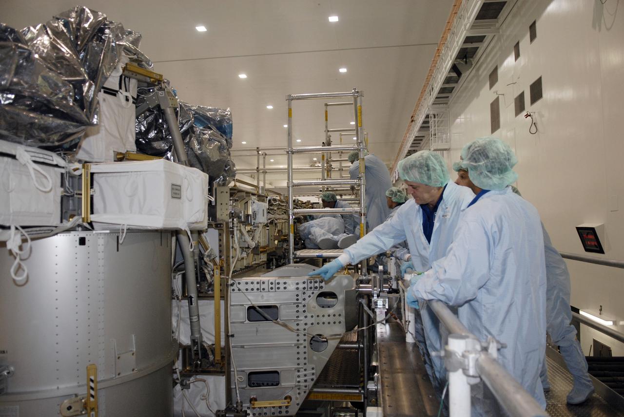 CAPE CANAVERAL, Fla. -- In the Space Station Processing Facility at NASA's Kennedy Space Center in Florida, STS-119 Mission Specialist Richard Arnold points to equipment that is part of the payload on the mission. Arnold and other crew members are at Kennedy for a Crew Equipment Interface Test that provides experience handling tools, equipment and hardware they will use on the mission. On the STS-119 mission, space shuttle Discovery will carry the S6 truss segment to complete the 361-foot-long backbone of the International Space Station. The truss includes the fourth pair of solar array wings and electronics that convert sunlight to power for the orbiting laboratory.  Discovery is targeted for launch on Feb. 12, 2009. Photo credit: NASA/Kim Shiflett