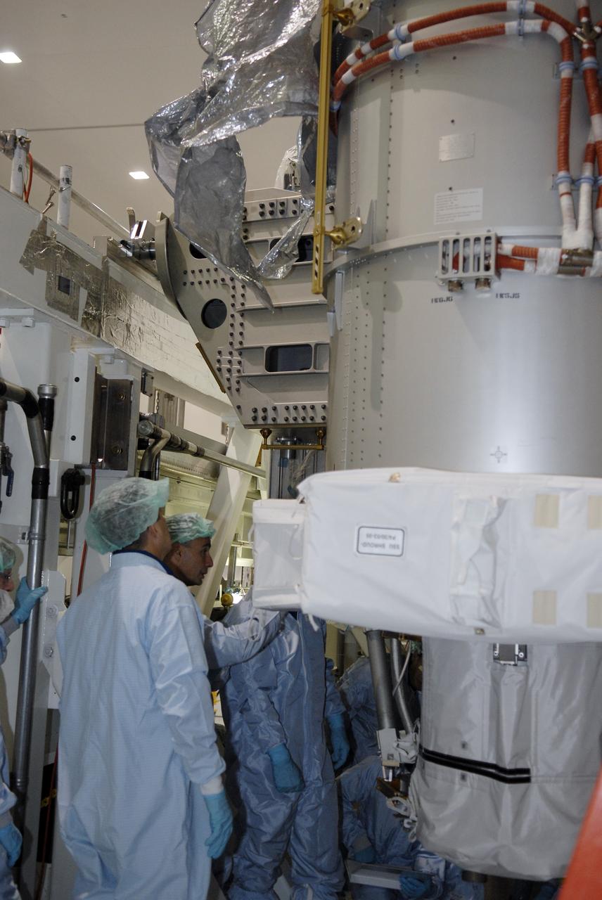 CAPE CANAVERAL, Fla. -- In the Space Station Processing Facility at NASA's Kennedy Space Center in Florida, STS-119 crew members take a close look at equipment that is part of the payload on the mission. The crew is at Kennedy for a Crew Equipment Interface Test that provides experience handling tools, equipment and hardware they will use on the mission. On the STS-119 mission, space shuttle Discovery will carry the S6 truss segment to complete the 361-foot-long backbone of the International Space Station. The truss includes the fourth pair of solar array wings and electronics that convert sunlight to power for the orbiting laboratory.  Discovery is targeted for launch on Feb. 12, 2009. Photo credit: NASA/Kim Shiflett