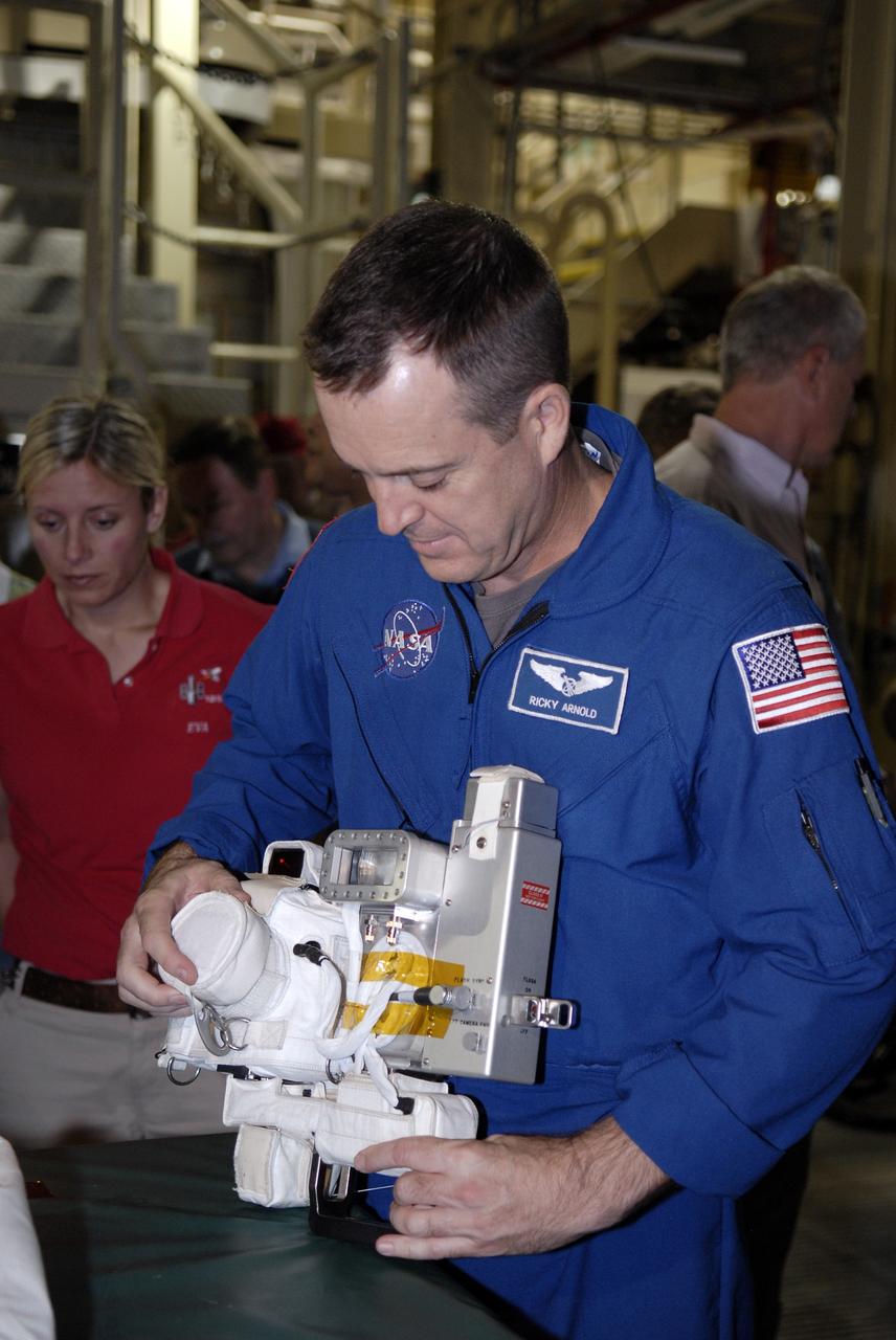 CAPE CANAVERAL, Fla. -- In the Orbiter Processing Facility at NASA's Kennedy Space Center in Florida, STS-119 Mission Specialist Richard Arnold practices with the camera to be used on the mission.  The crew is at Kennedy for a Crew Equipment Interface Test that provides experience handling tools, equipment and hardware they will use on the mission. On the STS-119 mission, space shuttle Discovery will carry the S6 truss segment to complete the 361-foot-long backbone of the International Space Station. The truss includes the fourth pair of solar array wings and electronics that convert sunlight to power for the orbiting laboratory.  Discovery is targeted for launch on Feb. 12, 2009. Photo credit: NASA/Kim Shiflett