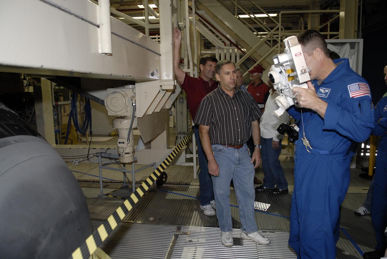 CAPE CANAVERAL, Fla. -- In the Orbiter Processing Facility at NASA's Kennedy Space Center in Florida, STS-119 Mission Specialist Richard Arnold practices using the camera to be used on the mission.  The crew is at Kennedy for a Crew Equipment Interface Test that provides experience handling tools, equipment and hardware they will use on the mission. On the STS-119 mission, space shuttle Discovery will carry the S6 truss segment to complete the 361-foot-long backbone of the International Space Station. The truss includes the fourth pair of solar array wings and electronics that convert sunlight to power for the orbiting laboratory.  Discovery is targeted for launch on Feb. 12, 2009. Photo credit: NASA/Kim Shiflett