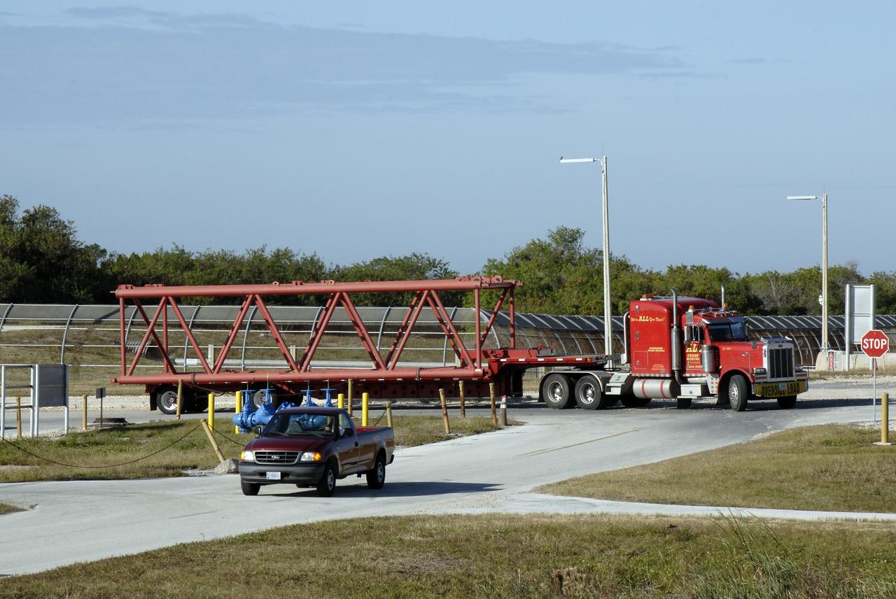 CAPE CANAVERAL, Fla. – One of 125 trucks begins delivering a segment of a giant crane to Launch Pad 39B at NASA's Kennedy Space Center in Florida. The crane will be constructed and used to finish erecting the lightning towers on the pad. Lightning towers are being constructed to hold catenary wires as part of the new lightning protection system for the Constellation Program and Ares/Orion launches. Photo credit: NASA/Kim Shiflett