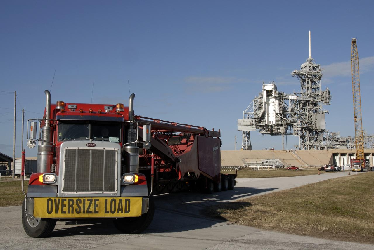 CAPE CANAVERAL, Fla. – Segments of a giant crane arrive by truck to Launch Pad 39B at NASA's Kennedy Space Center in Florida. The crane will be constructed and used to finish erecting the lightning towers on the pad. The crane segments arrived on 125 trucks. Lightning towers are being constructed to hold catenary wires as part of the new lightning protection system for the Constellation Program and Ares/Orion launches. Photo credit: NASA/Kim Shiflett