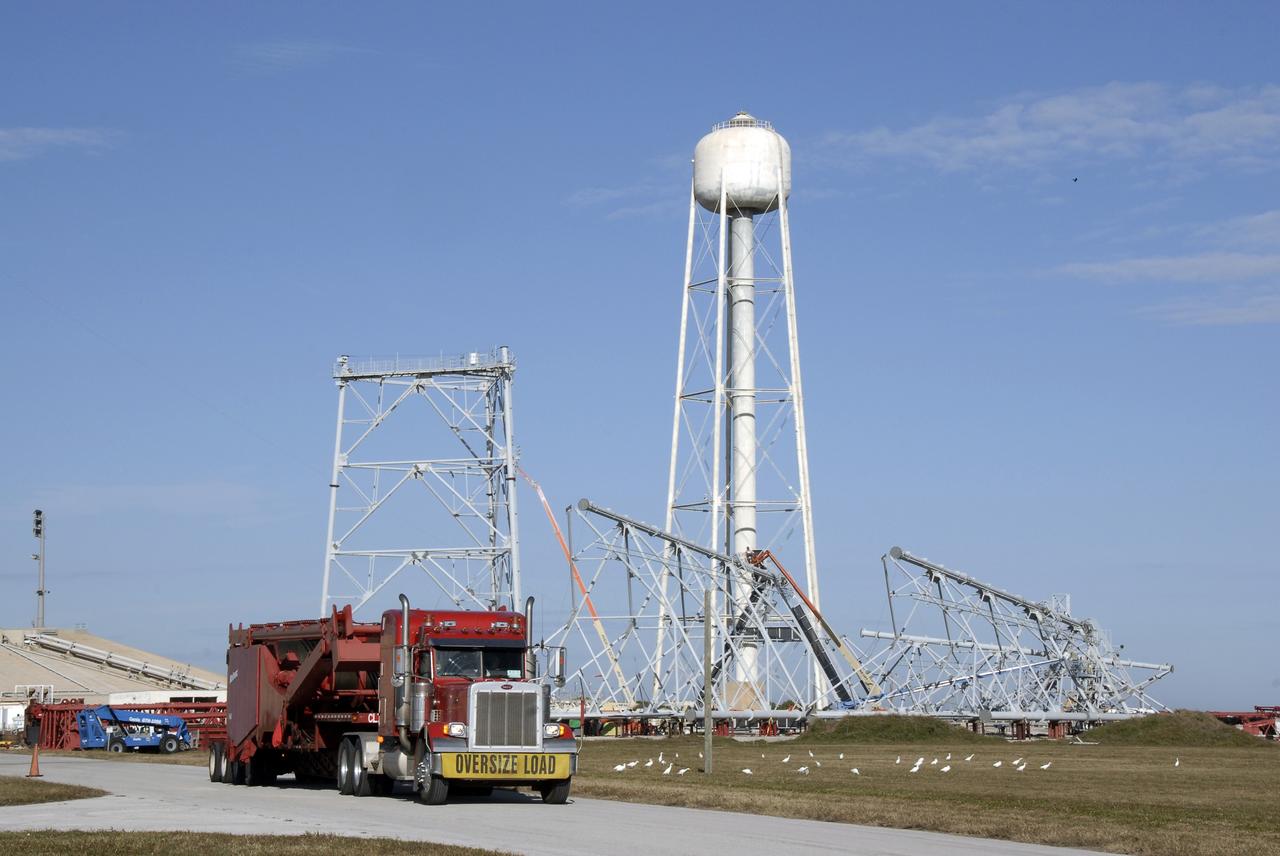 CAPE CANAVERAL, Fla. – Segments of a giant crane arrive by truck to Launch Pad 39B at NASA's Kennedy Space Center in Florida. The crane will be constructed and used to finish erecting the lightning towers on the pad. The crane segments arrived on 125 trucks. Lightning towers are being constructed to hold catenary wires as part of the new lightning protection system for the Constellation Program and Ares/Orion launches. Photo credit: NASA/Kim Shiflett