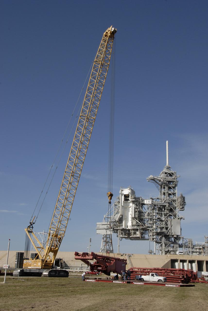 CAPE CANAVERAL, Fla. – On Launch Pad 39B at NASA's Kennedy Space Center in Florida, a giant crane is under construction to help finish erecting the lightning towers on the pad. The crane segments arrived on 125 trucks. Lightning towers are being constructed to hold catenary wires as part of the new lightning protection system for the Constellation Program and Ares/Orion launches. Photo credit: NASA/Kim Shiflett