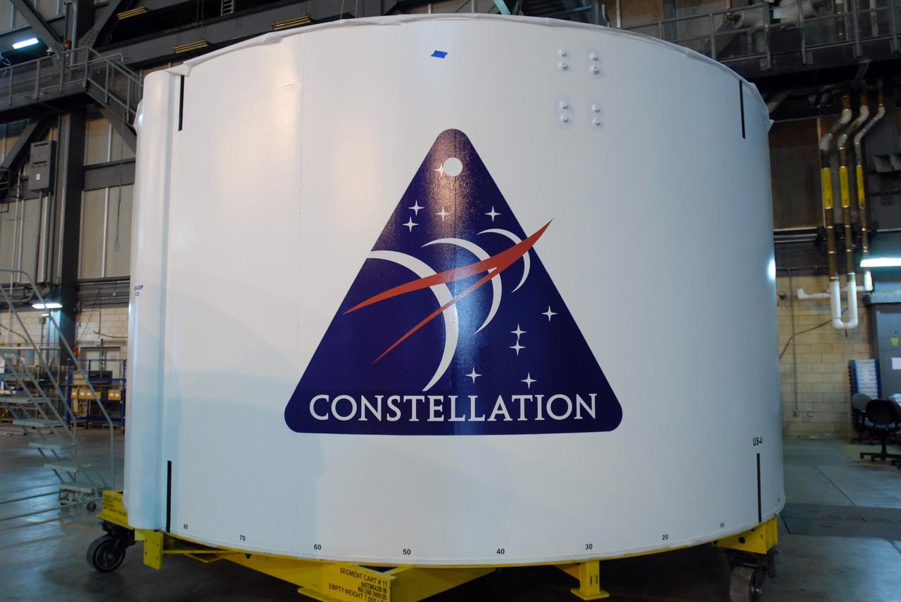 CAPE CANAVERAL, Fla. – In the Vehicle Assembly Building high bay 4 at NASA's Kennedy Space Center in Florida, one of the Ares I-X upper stage simulator segments bears the decal with the logo of the Constellation Program. The upper stage simulator will be used in the test flight identified as Ares I-X in 2009.  Ares I is the essential core of a safe, reliable, cost-effective space transportation system that eventually will carry crewed missions back to the moon, on to Mars and out into the solar system. Ares I may also use its 25-ton payload capacity to deliver resources and supplies to the International Space Station, or to "park" payloads in orbit for retrieval by other spacecraft bound for the moon or other destinations.    Photo credit: NASA/Jim Grossmann
