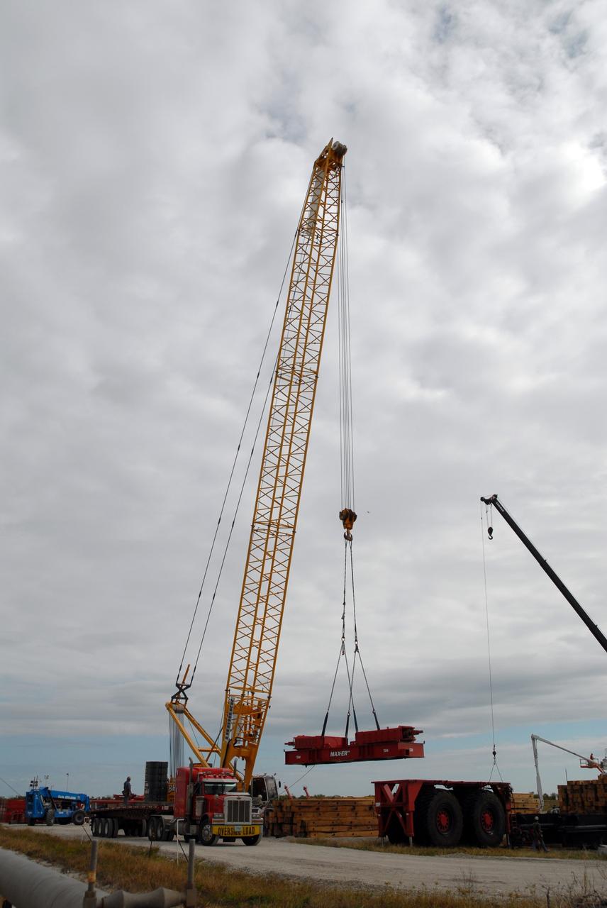CAPE CANAVERAL, Fla. - On Launch Pad 39B at NASA’s Kennedy Space Center in Florida, the giant crane moves equipment that will be used to continue erecting the lightning towers. Each of the three new lightning towers will be 500 feet tall with an additional 100-foot fiberglass mast atop supporting a wire centenary system.  This improved lightning protection system allows for the taller height of the Ares I compared to the space shuttle.  Pad B will be the site of the first Ares vehicle launch, including Ares I-X which is targeted for summer of 2009, as part of NASA’s Constellation Program.  Photo credit: NASA/Tim Jacobs
