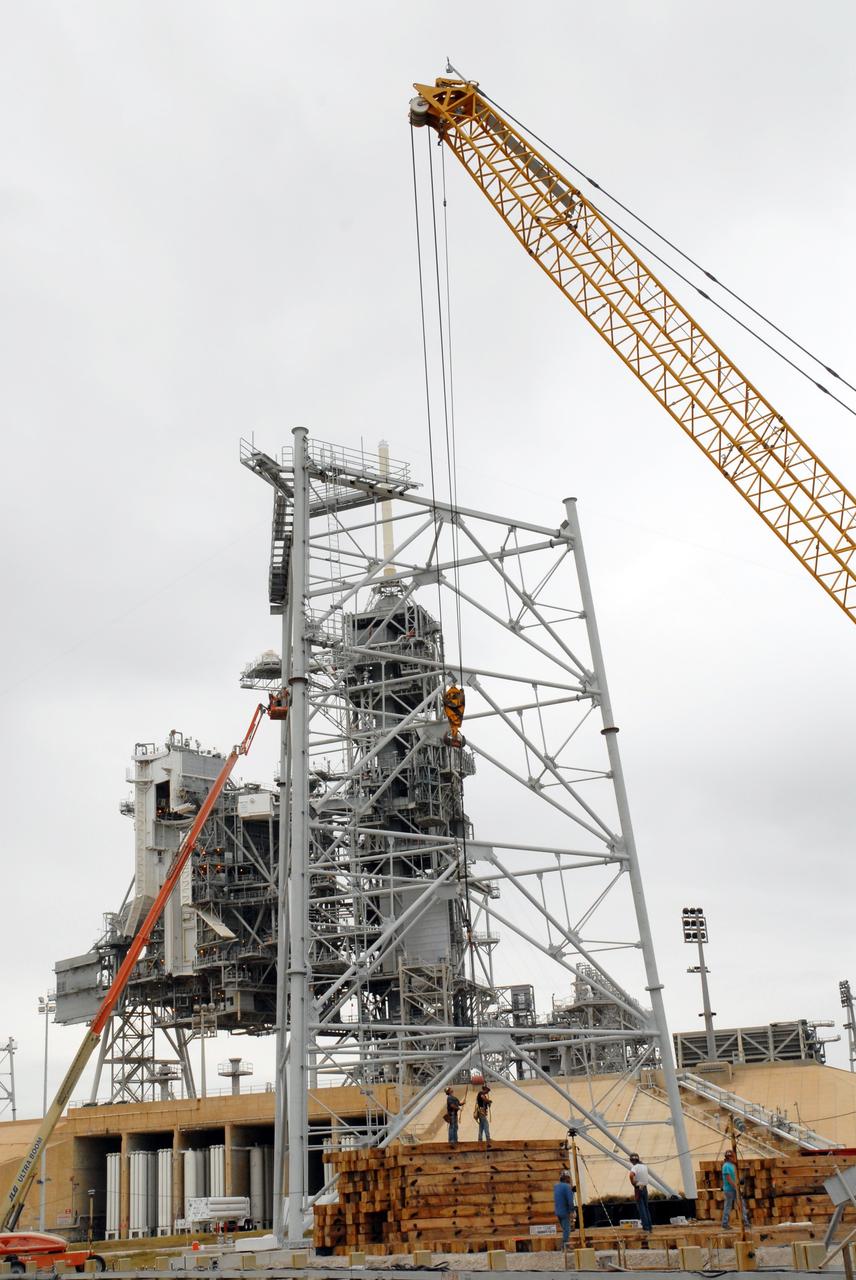 CAPE CANAVERAL, Fla. - On Launch Pad 39B at NASA’s Kennedy Space Center in Florida, the giant crane above is being used to help continue erecting the lightning towers. Each of the three new lightning towers will be 500 feet tall with an additional 100-foot fiberglass mast atop supporting a wire centenary system.  This improved lightning protection system allows for the taller height of the Ares I compared to the space shuttle.  Pad B will be the site of the first Ares vehicle launch, including Ares I-X which is targeted for summer of 2009, as part of NASA’s Constellation Program.  Photo credit: NASA/Tim Jacobs