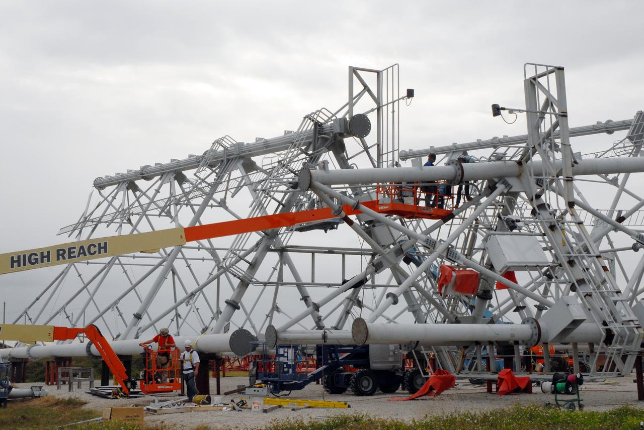 CAPE CANAVERAL, Fla. - The new lightning towers are under construction on Launch Pad 39B at NASA’s Kennedy Space Center in Florida.  Each of the three new lightning towers will be 500 feet tall with an additional 100-foot fiberglass mast atop supporting a wire centenary system.  This improved lightning protection system allows for the taller height of the Ares I compared to the space shuttle.  Pad B will be the site of the first Ares vehicle launch, including Ares I-X which is targeted for summer of 2009, as part of NASA’s Constellation Program.  Photo credit: NASA/Tim Jacobs