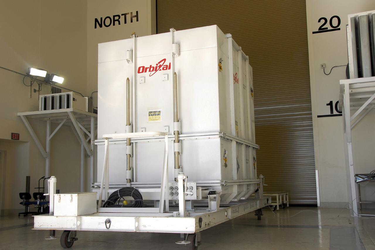 VANDENBERG AIR FORCE BASE, Calif. -- The Orbiting Carbon Observatory, or OCO, spacecraft, shipped from spacecraft facilities in Dulles, Va., by Orbital Sciences, has been moved inside the Astrotech payload processing facility, building 1032, at Vandenberg Air Force Base in California. After the protective coverings over the spacecraft are removed, blanket preparations and edge taping will be done, followed by mechanical preparations and work on the electronic ground support equipment. The OCO is a new Earth-orbiting mission sponsored by NASA's Earth System Science Pathfinder Program. The observatory is targeted to launch Jan. 15 from Space Launch Complex 576-E at Vandenberg. Photo credit: NASA/Robert Hargreaves Jr., VAFB