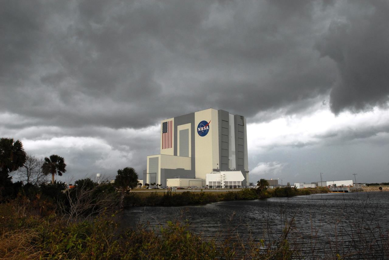 CAPE CANAVERAL, Fla. –-  Dark gray clouds hover over the Vehicle Assembly Building at NASA's Kennedy Space Center in Florida, part of a strong weather system that included crosswinds and anvil clouds blowing across the state. The weather concerns prevented space shuttle Endeavour and its crew from returning to Kennedy, the primary end-of-mission landing site.  Instead, Endeavour landed safely at 4:25 p.m. at Edwards Air Force Base in California after traveling more than 6.6 million miles in space. The main landing gear touched down at Edwards at 4:25:06 p.m. EST. The nose landing gear touched down at 4:25:21 p.m. and wheel stop was at 4:26:03 p.m. The STS-126 mission was the 27th flight to the International Space Station, carrying equipment and supplies in the Multi-Purpose Logistics Module Leonardo. The mission featured four spacewalks and work to prepare the space station to house six crew members for long-duration missions.   Photo credit: NASA/Jim Grossmann