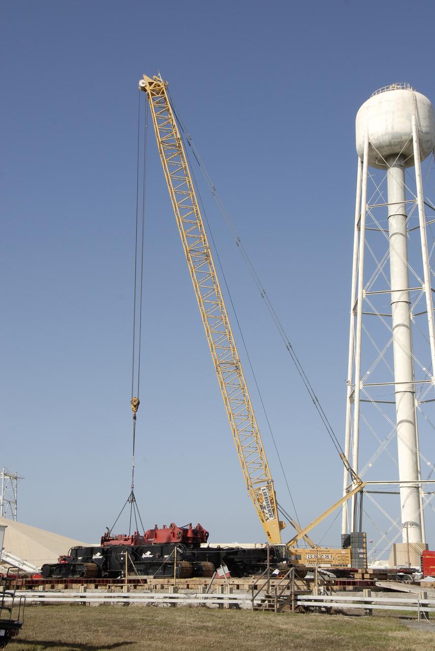 CAPE CANAVERAL, Fla. --   On Launch Pad 39B at NASA’s Kennedy Space Center in Florida, the giant crane moves equipment that will be used to continue erecting the lightning towers. Each of the three new lightning towers will be 500 feet tall with an additional 100-foot fiberglass mast atop supporting a wire catenary system. This improved lightning protection system allows for the taller height of the Ares I compared to the space shuttle. Pad B will be the site of the first Ares vehicle launch, including Ares I-X which is targeted for summer of 2009, as part of NASA’s Constellation Program. Photo credit: NASA/Kim Shiflett