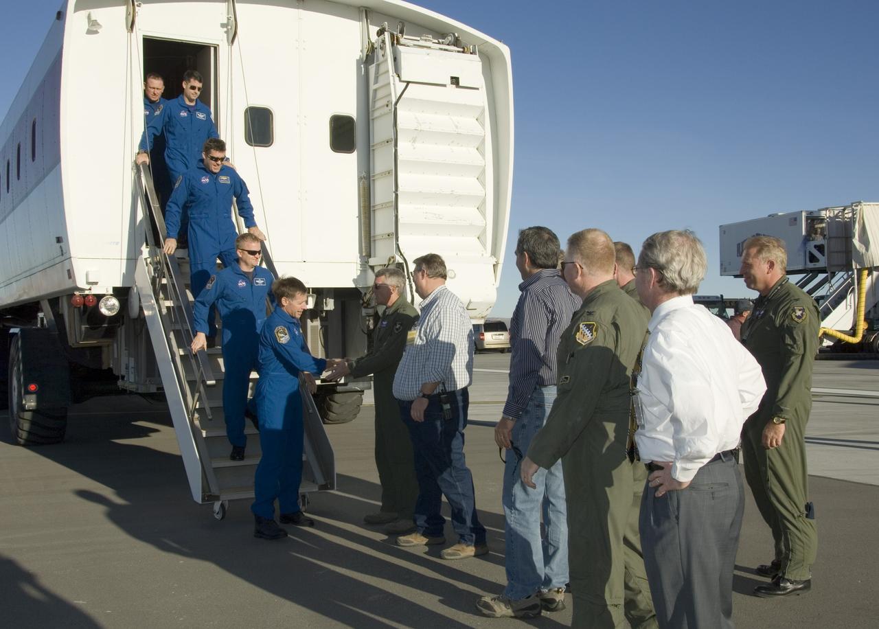 EDWARDS, Calif. – At Edwards Air Force Base in California, STS-126 crew members are greeted as they exit the crew transport vehicle after landing aboard space shuttle Endeavour.  Leading the crew is Commander Chris Ferguson (right) followed by Pilot Eric Boe and Mission Specialists Steve Bowen and Shane Kimbrough.  The decision to land at Edwards was made due to weather concerns at NASA's Kennedy Space Center in Florida.  In the 52nd landing at Edwards, Endeavour touched down at 4:25 p.m. EST to end the STS-126 mission, completing its 16-day journey of over 6.6 million miles in space. The STS-126 mission was the 27th flight to the International Space Station, carrying equipment and supplies in the Multi-Purpose Logistics Module Leonardo. The mission featured four spacewalks and work to prepare the space station to house six crew members for long-duration missions.   Photo credit: NASA/Tom Tschida, VAFB