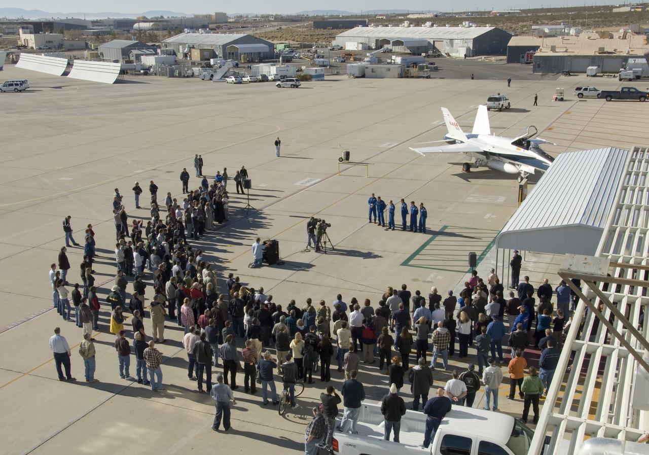 EDWARDS, Calif. –   At Edwards Air Force Base in California, photographers and journalists circle STS-126 crew members before their departure for NASA's Johnson Space Center in Houston.  The crew took time to talk to the media before they left.  The decision to land space shuttle Endeavour at Edwards was made due to weather concerns at NASA's Kennedy Space Center in Florida.  In the 52nd landing at Edwards, Endeavour touched down at 4:25 p.m. EST on Nov. 30 to end the STS-126 mission, completing its 16-day journey of over 6.6 million miles in space. The STS-126 mission was the 27th flight to the International Space Station, carrying equipment and supplies in the Multi-Purpose Logistics Module Leonardo. The mission featured four spacewalks and work to prepare the space station to house six crew members for long-duration missions.  Photo credit: NASA/Tony Landis, VAFB